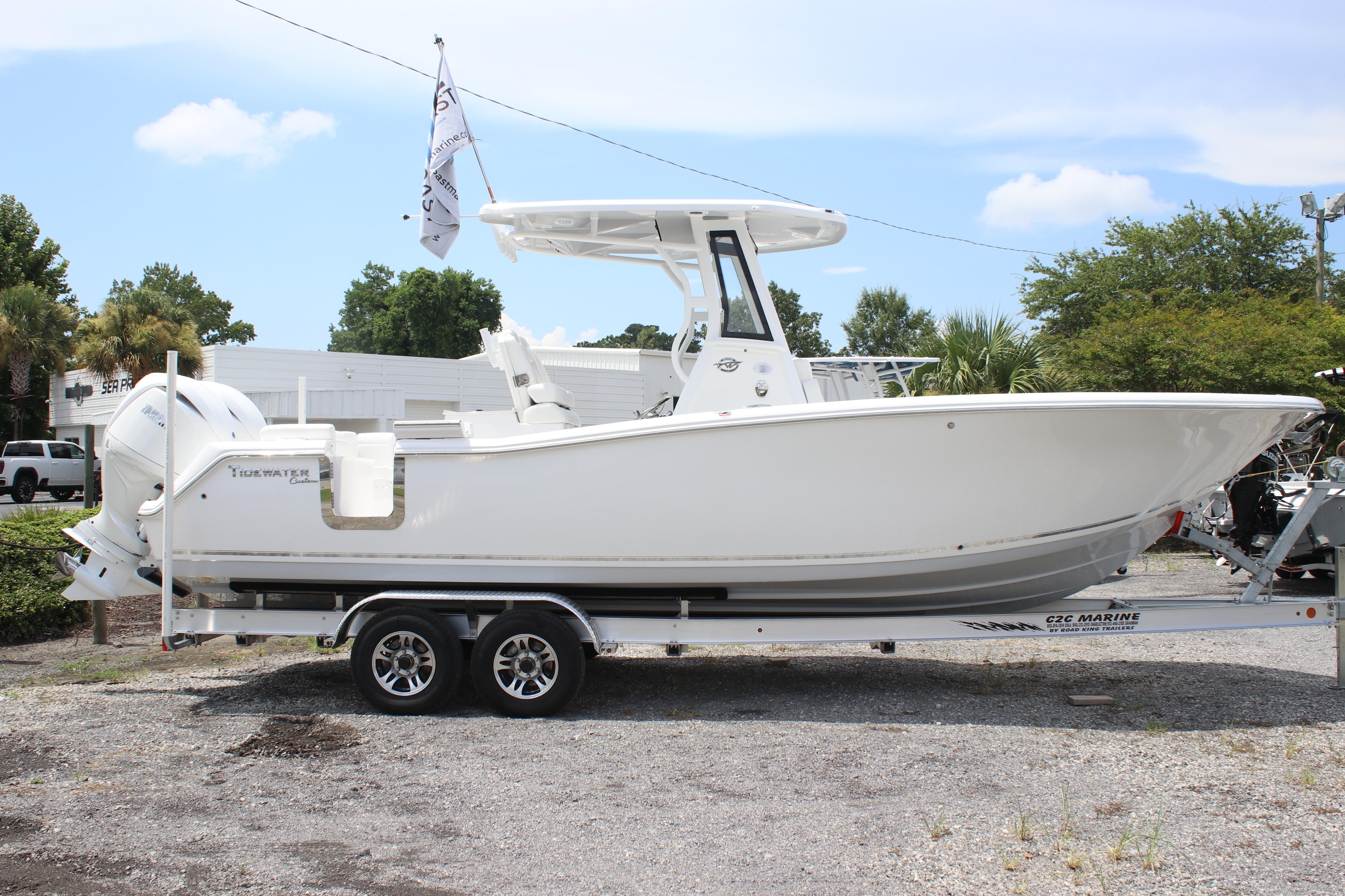 2026 Tidewater 272 LXF boat on trailer, side view, outdoors, clear sky.