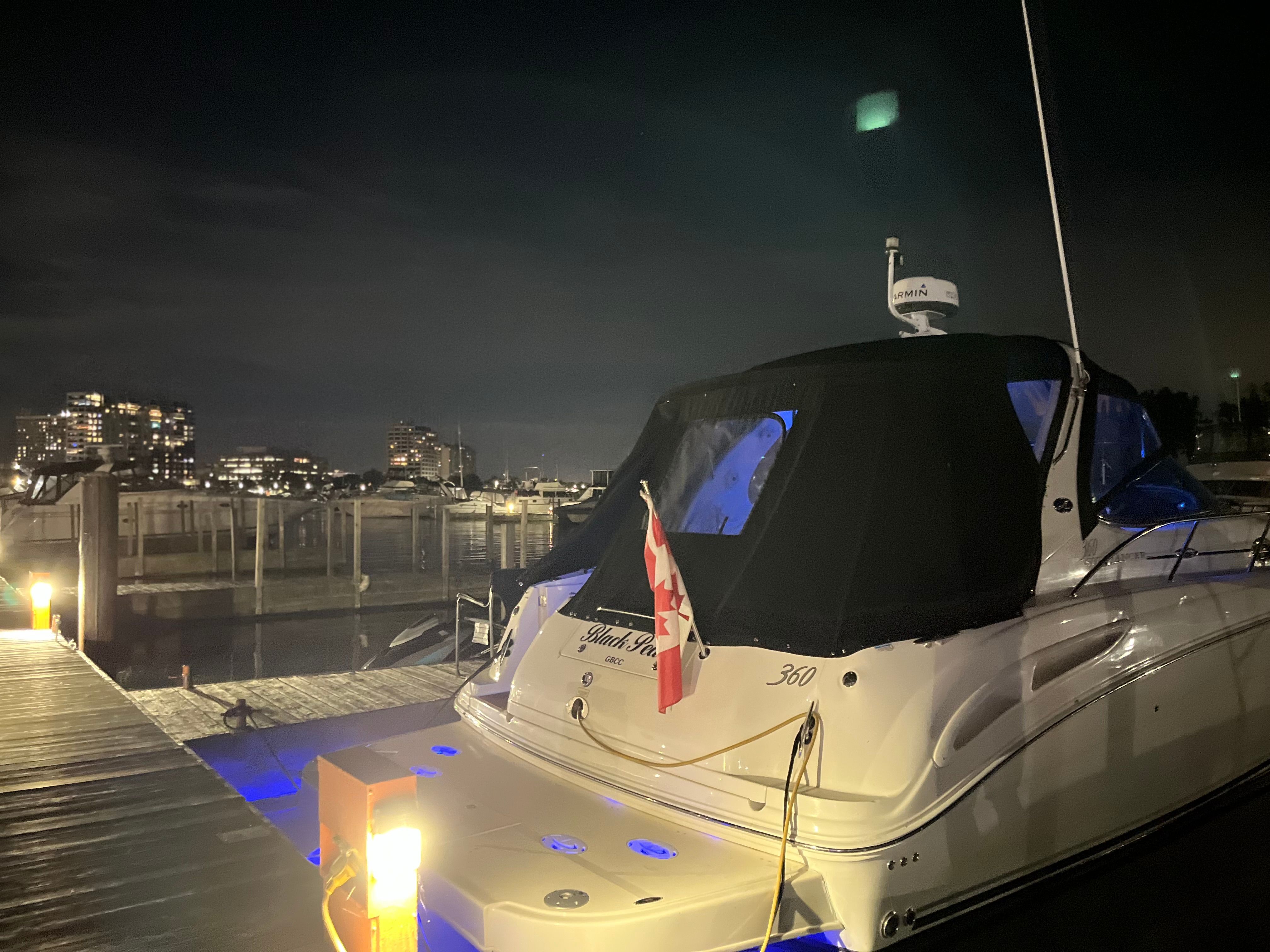 2005 Sea Ray Sundancer yacht docked at night.