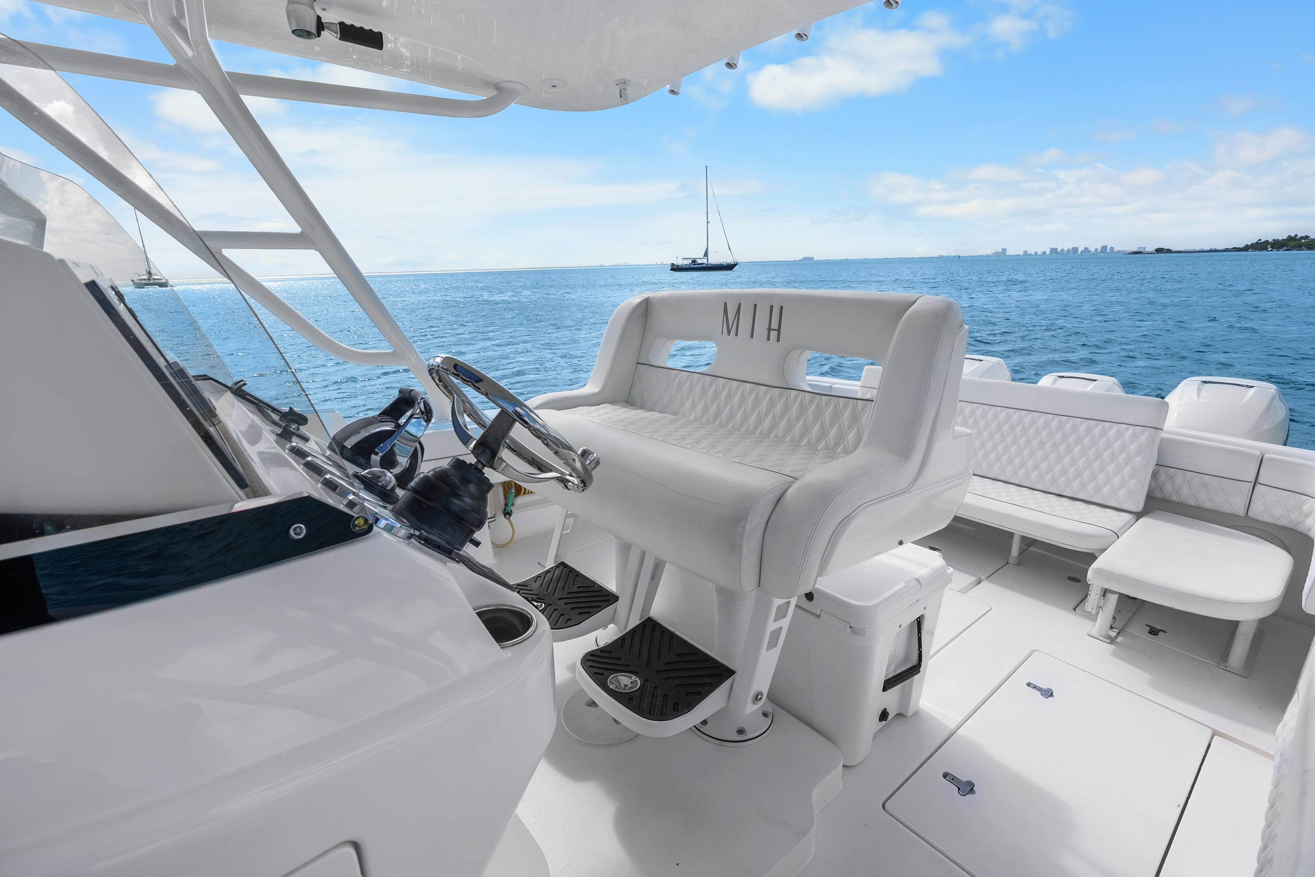 2013 Intrepid 400 Cuddy boat interior with white seating and ocean view.