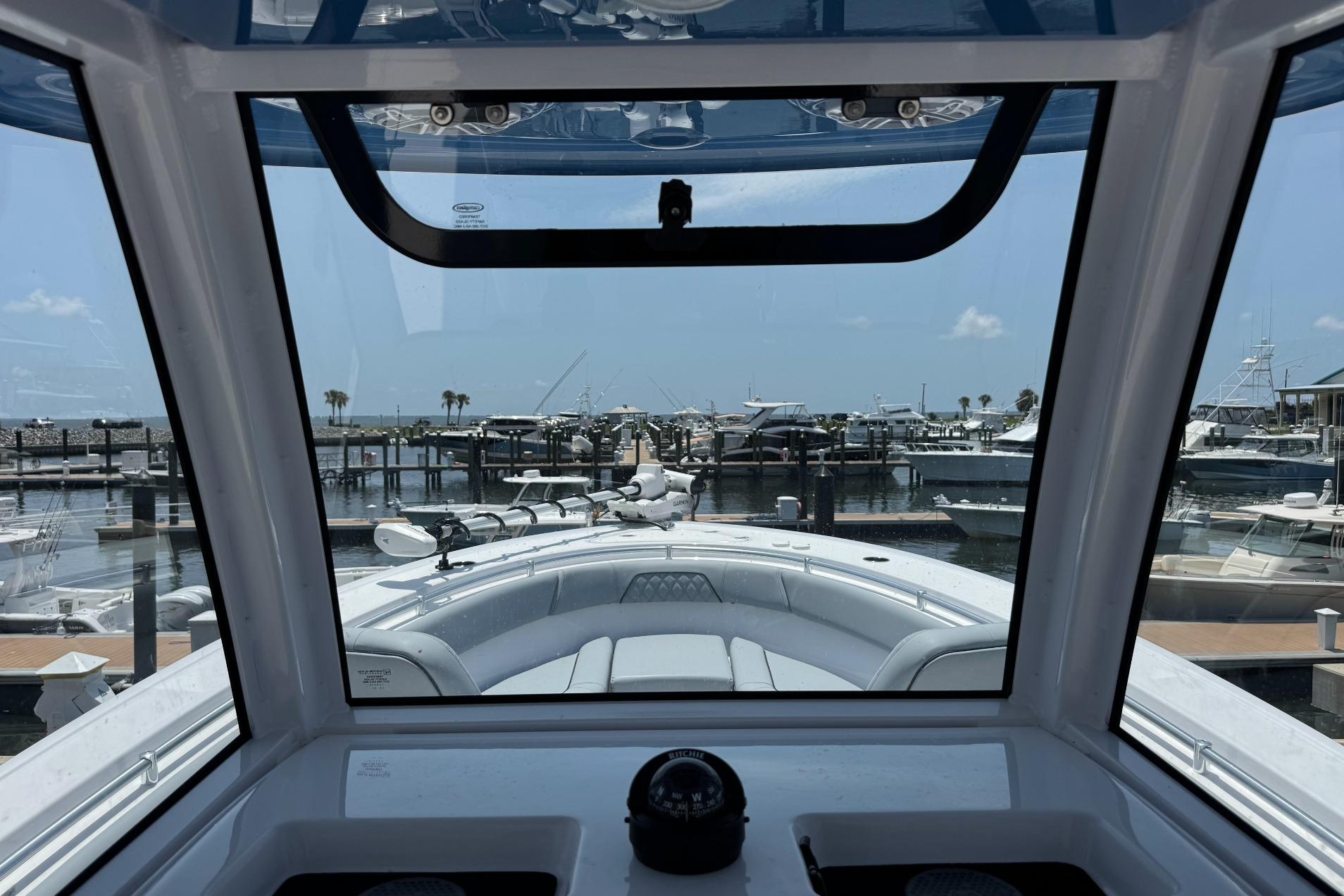 2026 Sportsman Open 262 Center Console boat docked at marina, viewed from helm.