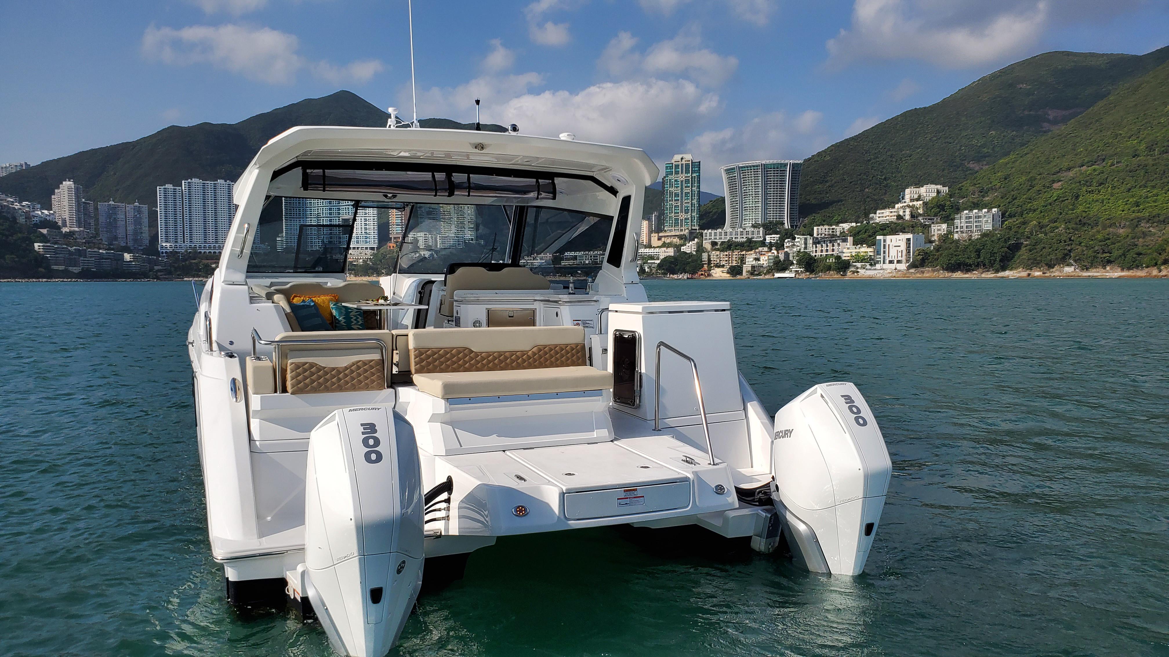 Aquila 36 Sport 2020 boat on water with scenic coastal backdrop.