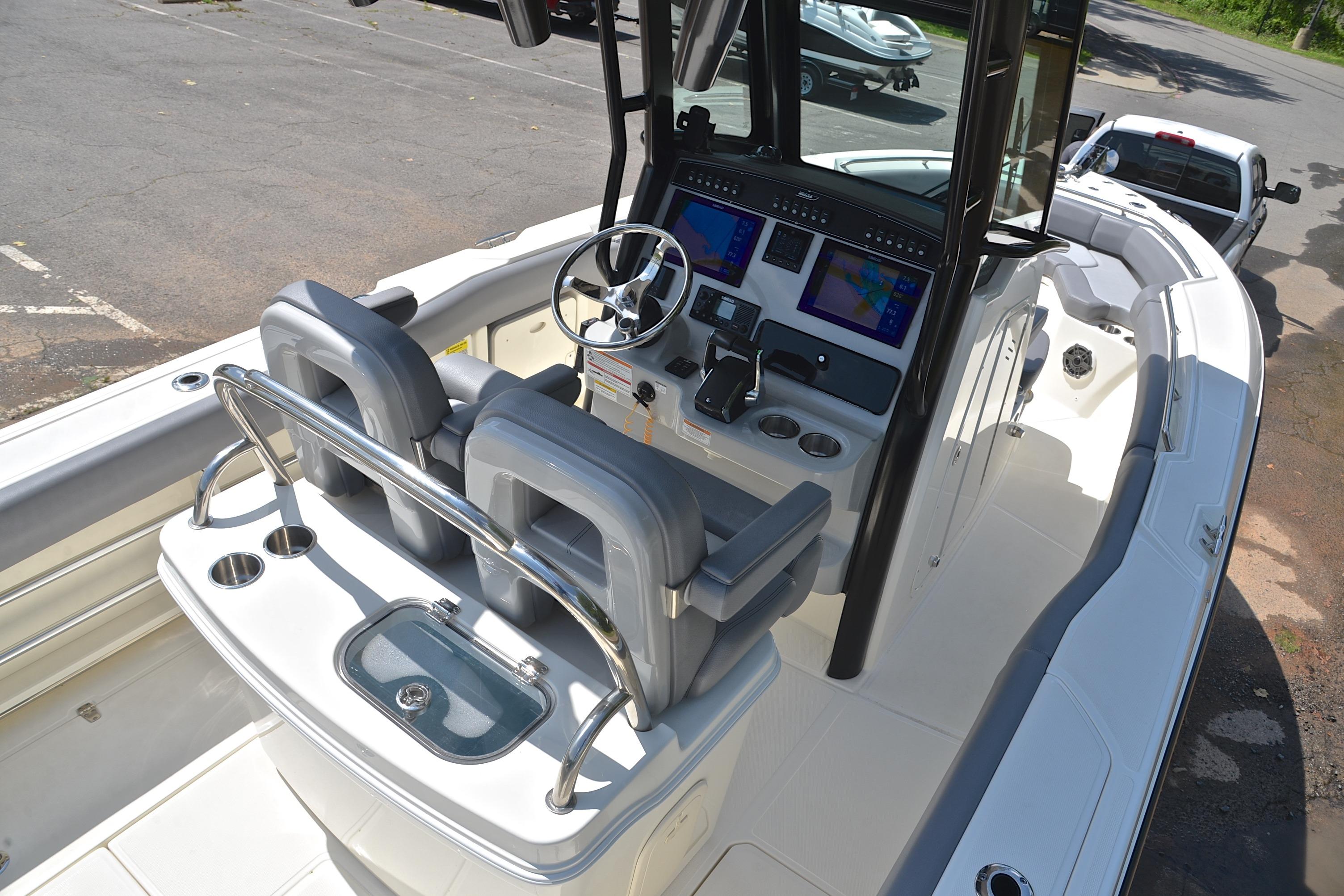 2024 Boston Whaler 250 Outrage boat interior with dual helm seats and advanced navigation system.