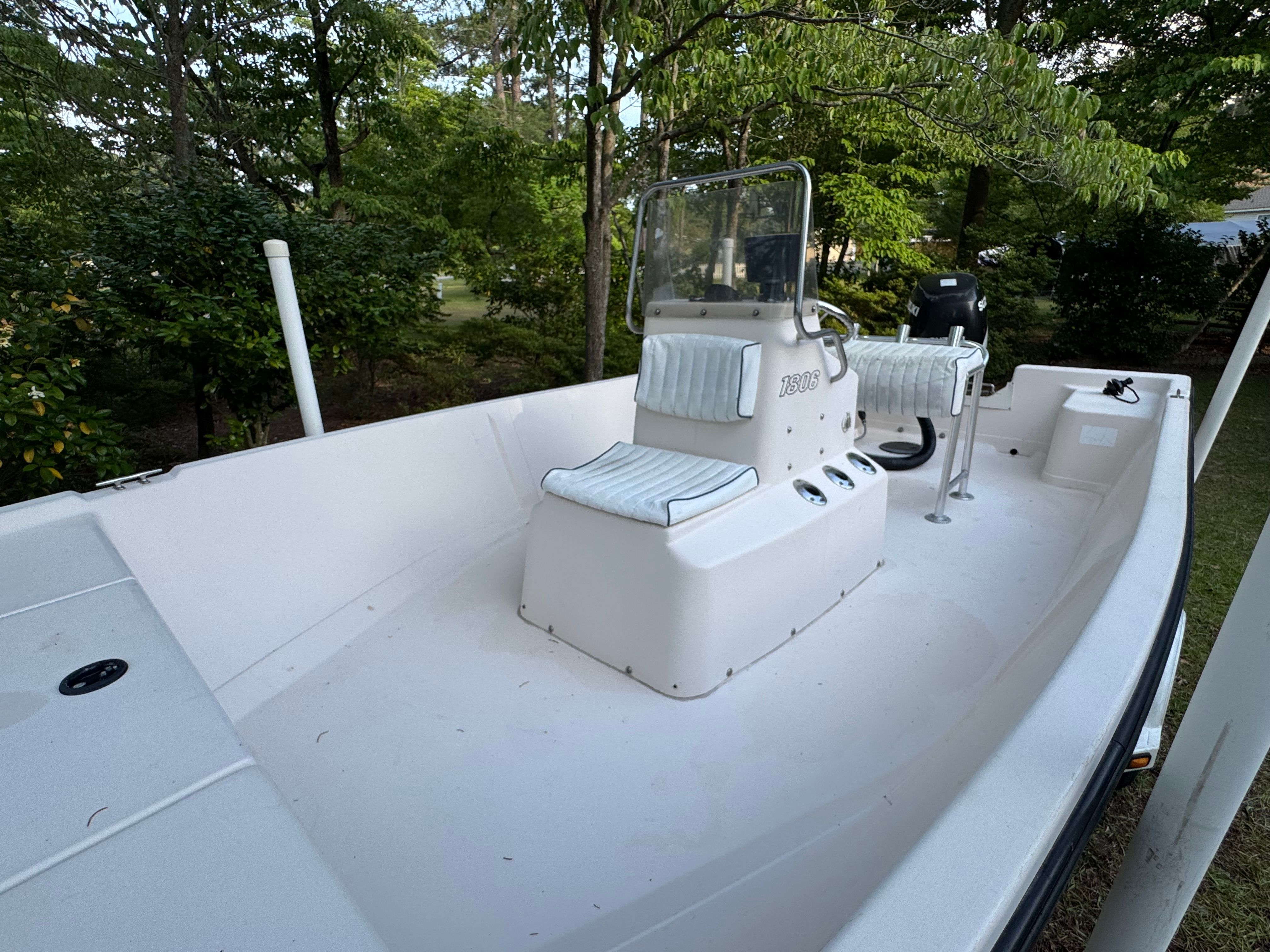 A 2002 Maverick Pathfinder 1806 V boat with a white deck and steering console.