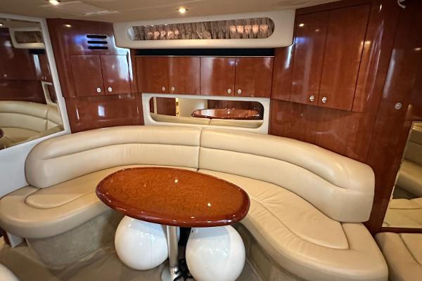 Luxurious 2004 Sea Ray 380 Sundancer yacht interior with elegant seating and wooden cabinetry.
