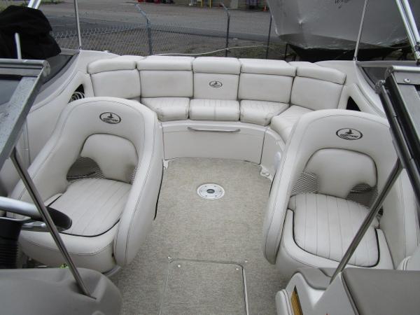 2004 Ebbtide 22 Mystique boat interior with white leather seating and carpeted floor.