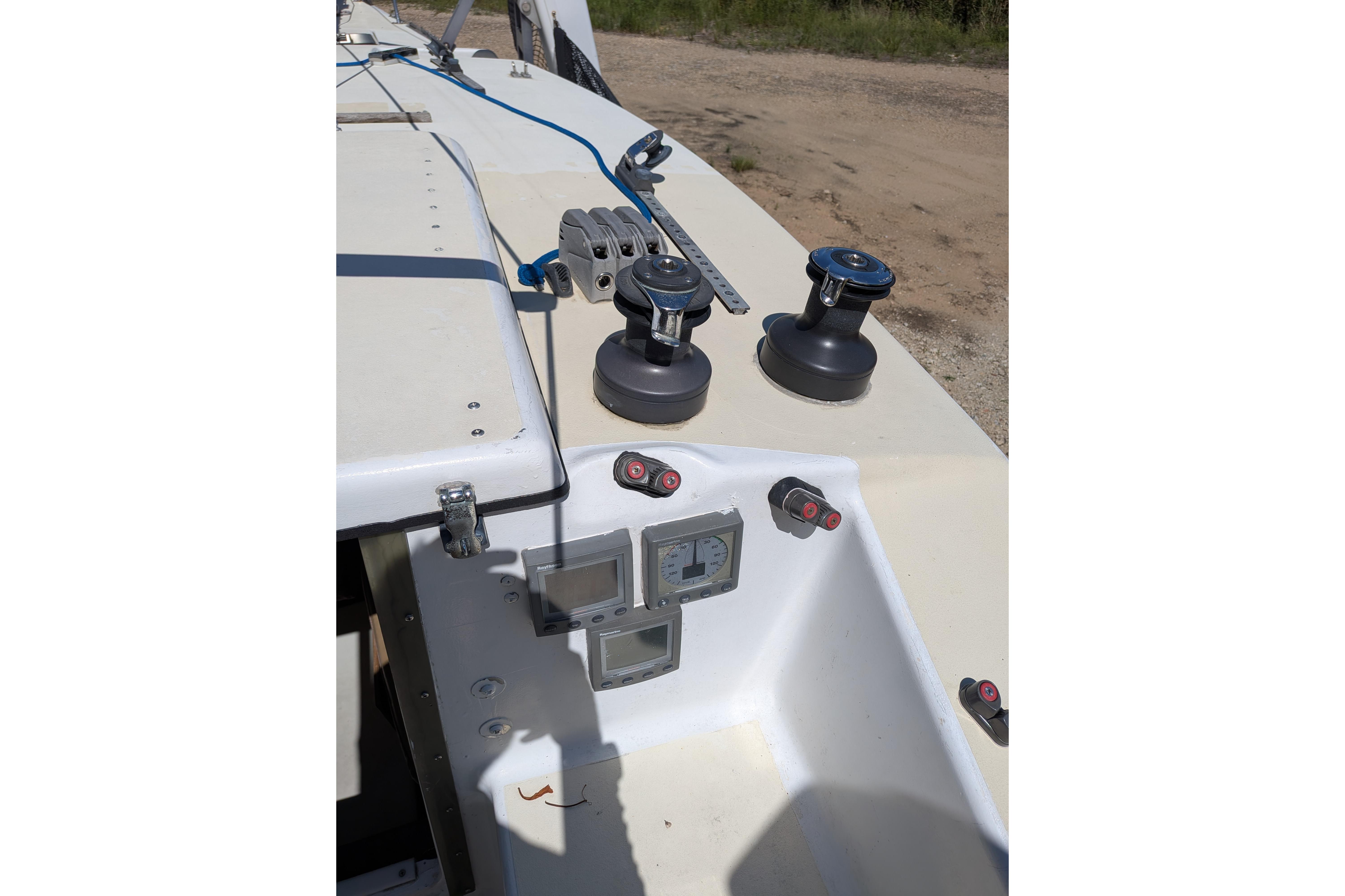 Cockpit of 1991 Corsair F-27 sailboat with winches and navigation instruments.