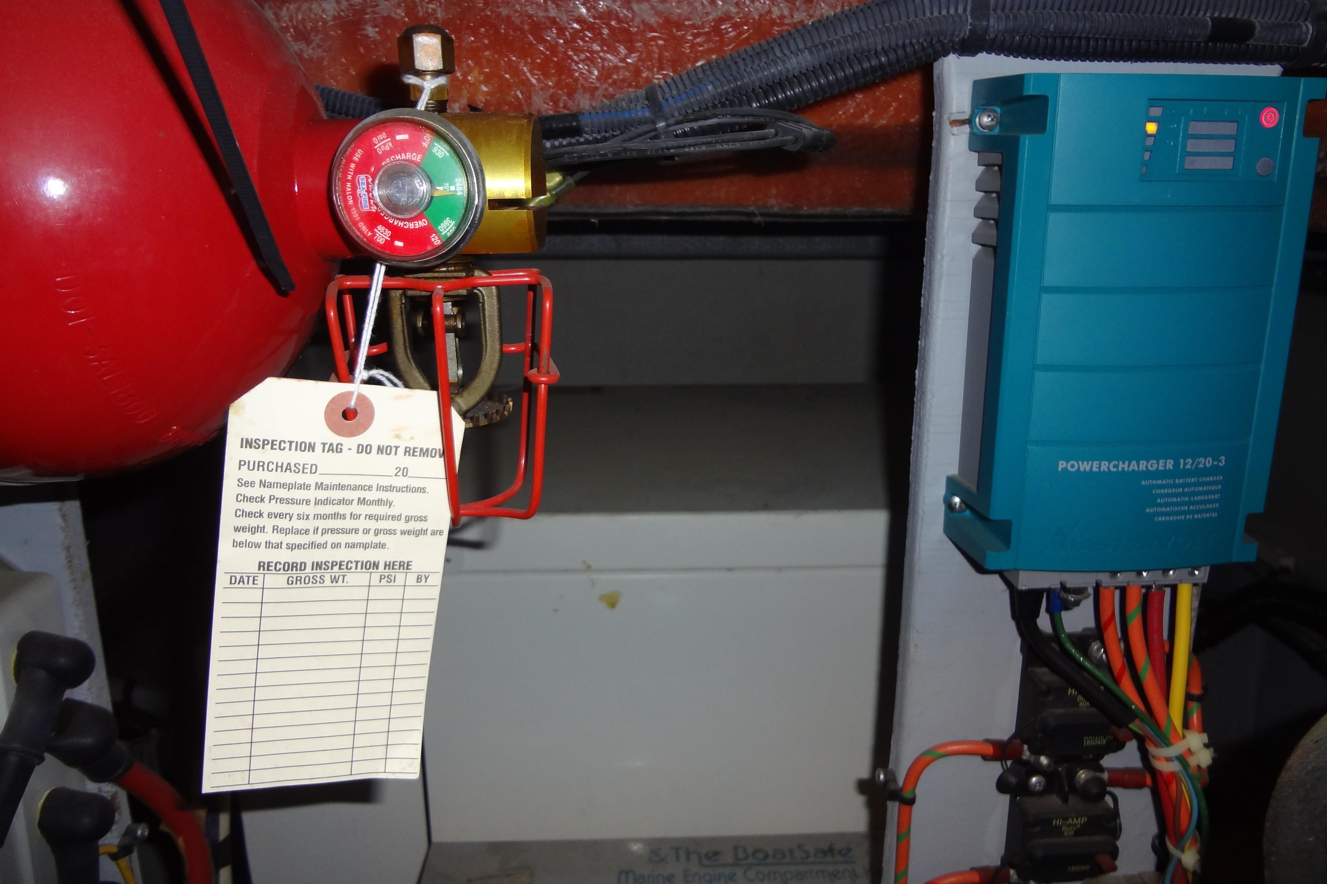 Engine room of 2005 Silverton 34 Convertible with fire extinguisher and power charger.