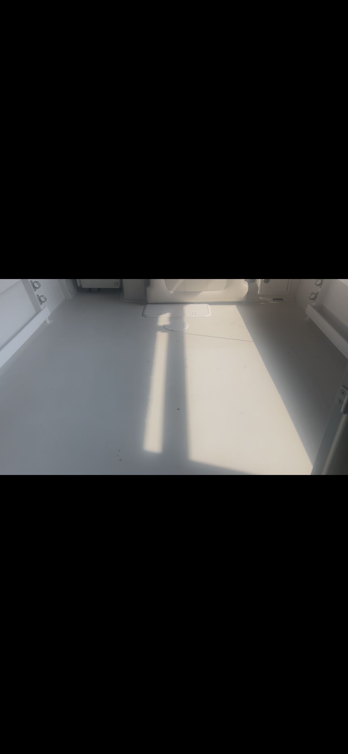 Interior of a Parker 2320 Sport Cabin boat, empty and clean.