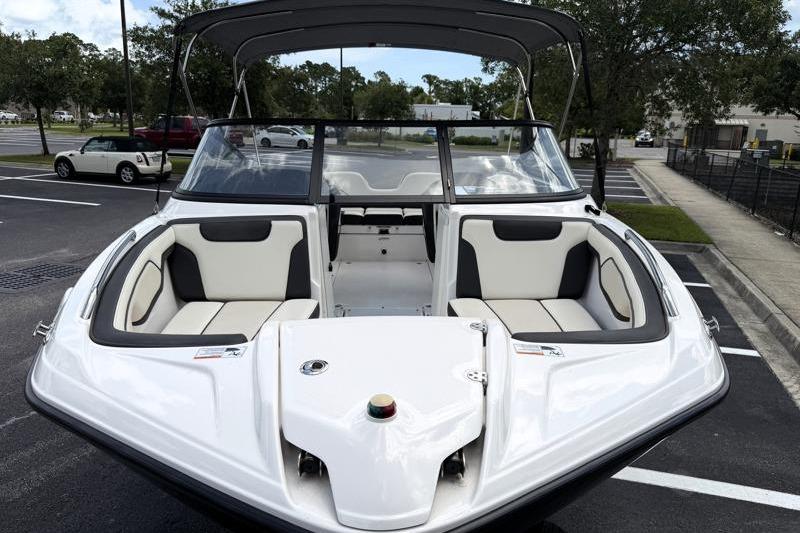 2017 Yamaha Boats SX210 with sleek design and spacious seating in a parking lot.