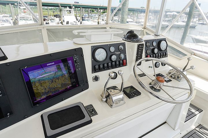 The cockpit of a 1987 Viking Rybovich 41 Convertible with steering wheel and navigation systems.