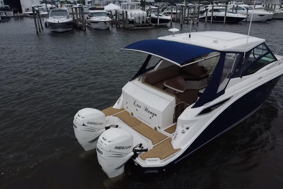 2021 Sea Ray Sundancer 320 Outboard docked, featuring dual Mercury engines and sleek design.