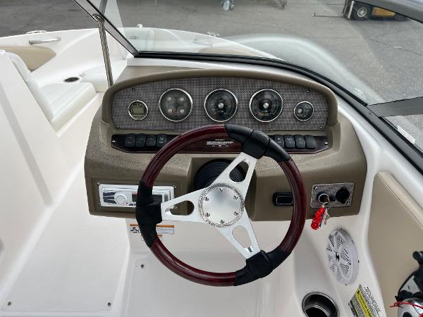 2013 Regal 1900 boat dashboard with steering wheel and instrument panel.