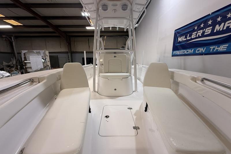 2026 Sea Pro 202 Center Console boat interior with seating and storage in a showroom.