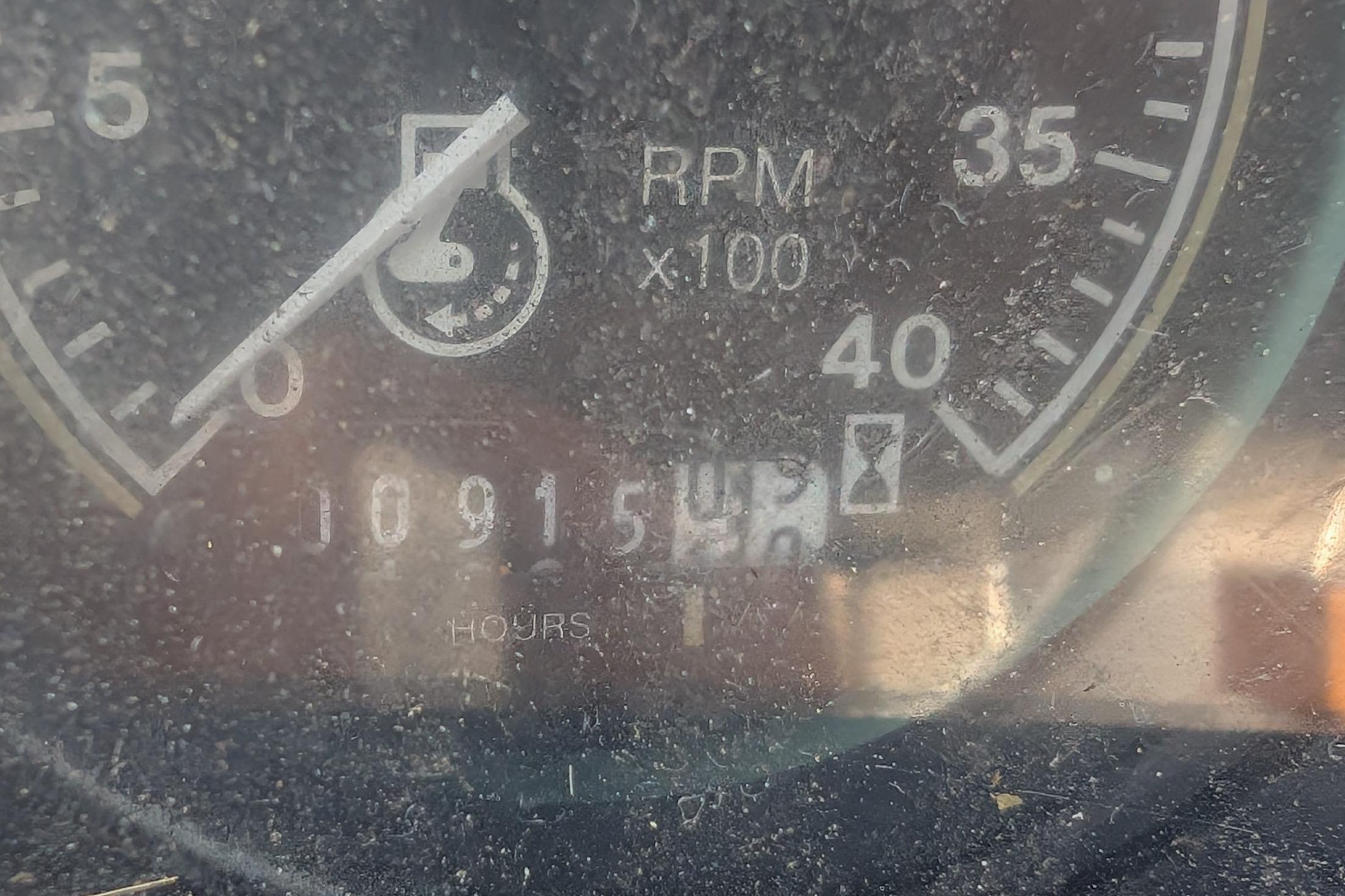 Close-up of a Catalina 34 tachometer showing 10915 hours and RPM gauge.
