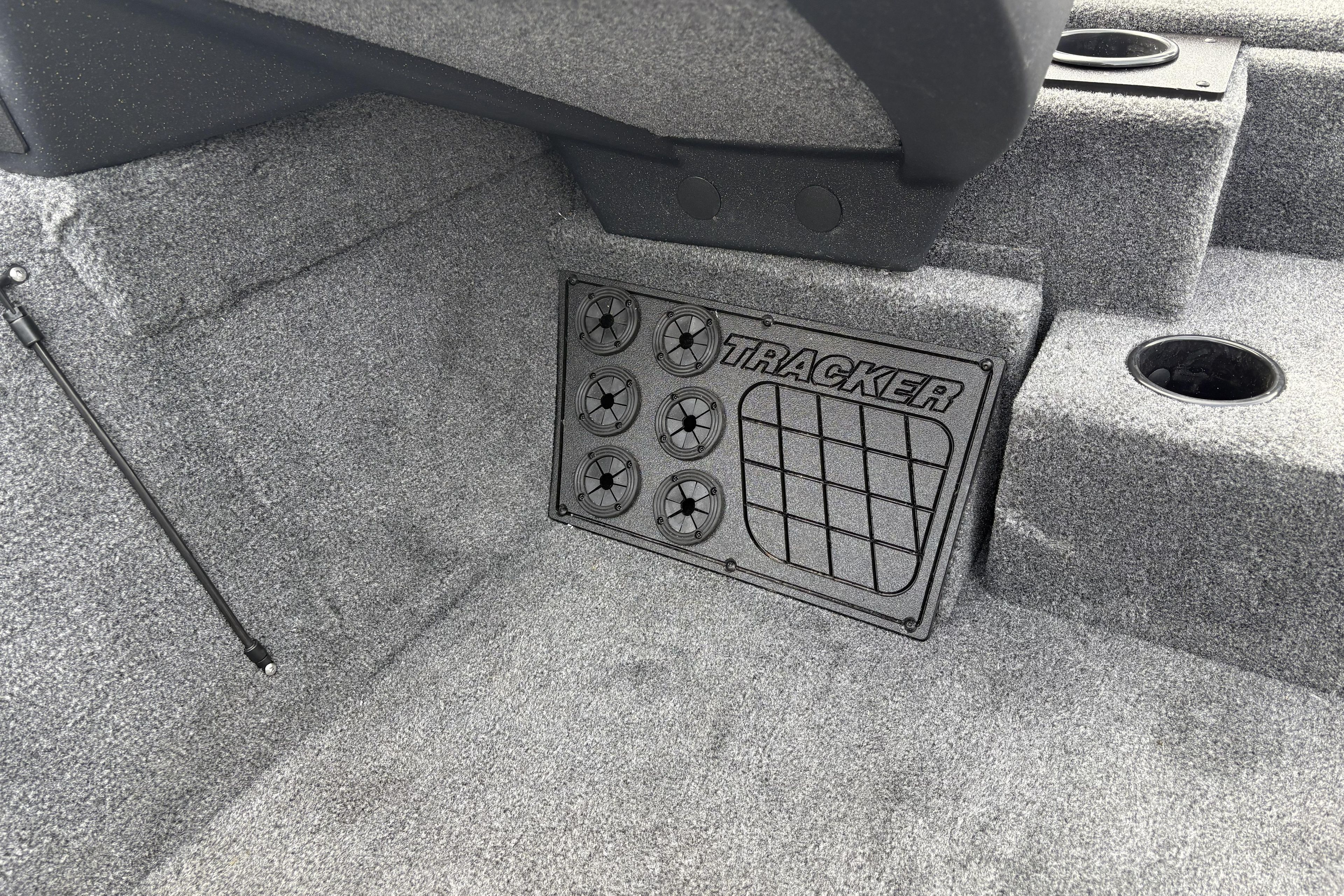 Interior of 2026 Tracker Pro Team 195 boat with carpeted flooring and storage compartment.