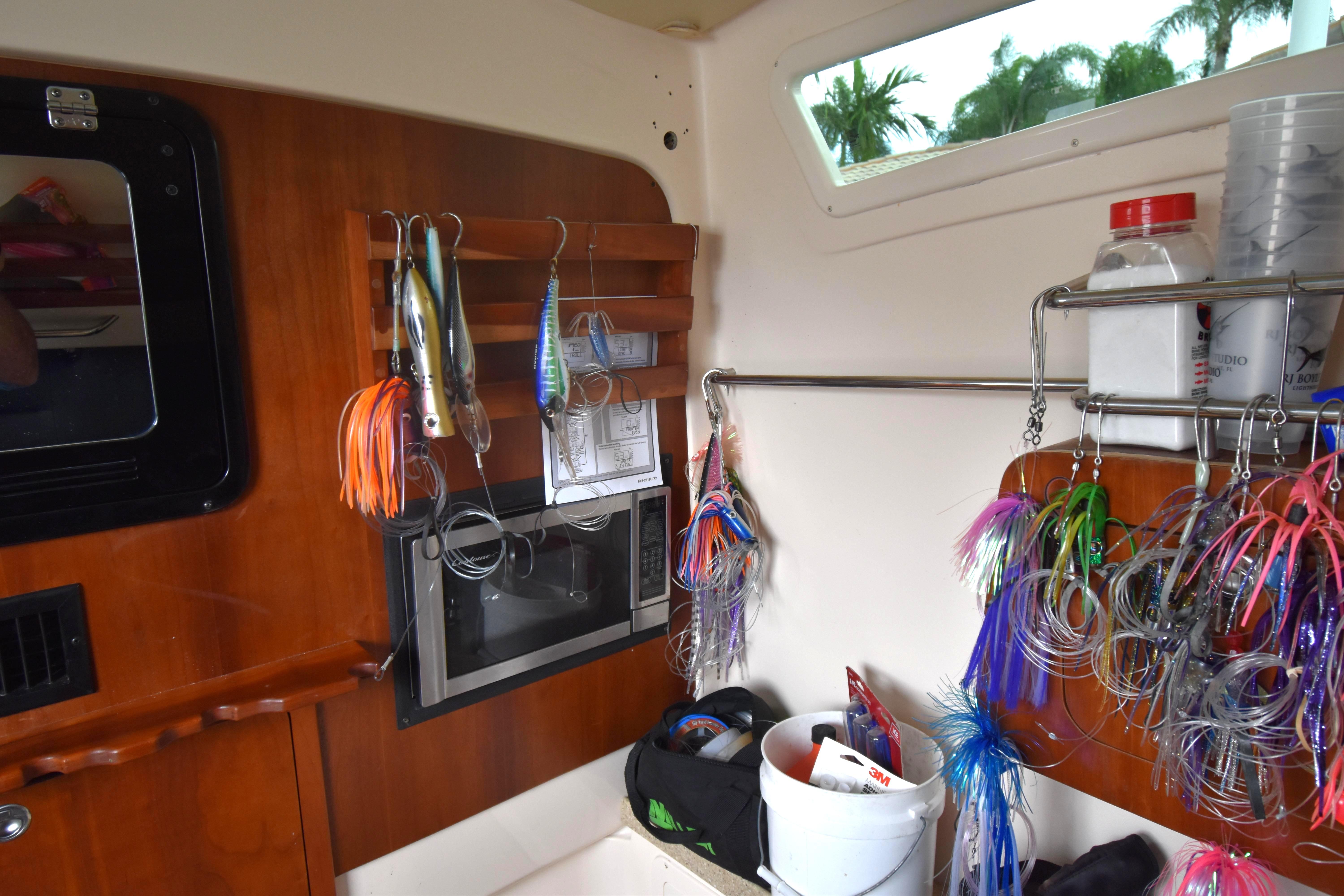 Interior of a 2010 Grady-White Canyon 366 boat with fishing lures and equipment.