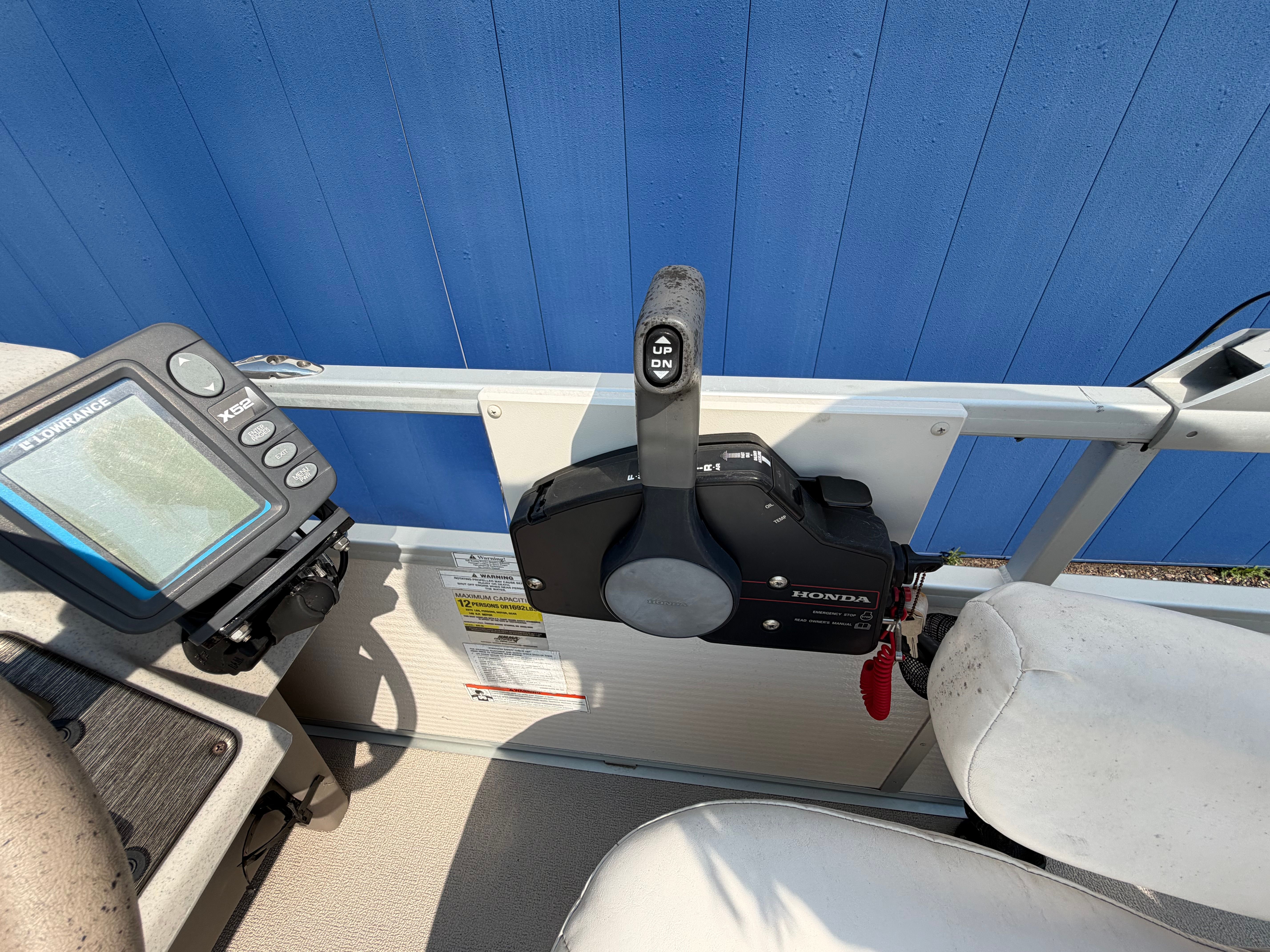 Close-up of a boat control system with Honda throttle and navigation device.