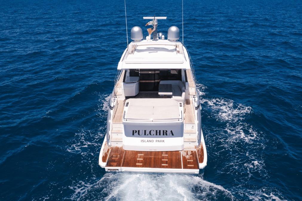 Azimut 60 yacht cruising on open sea, rear view, 2020 model.
