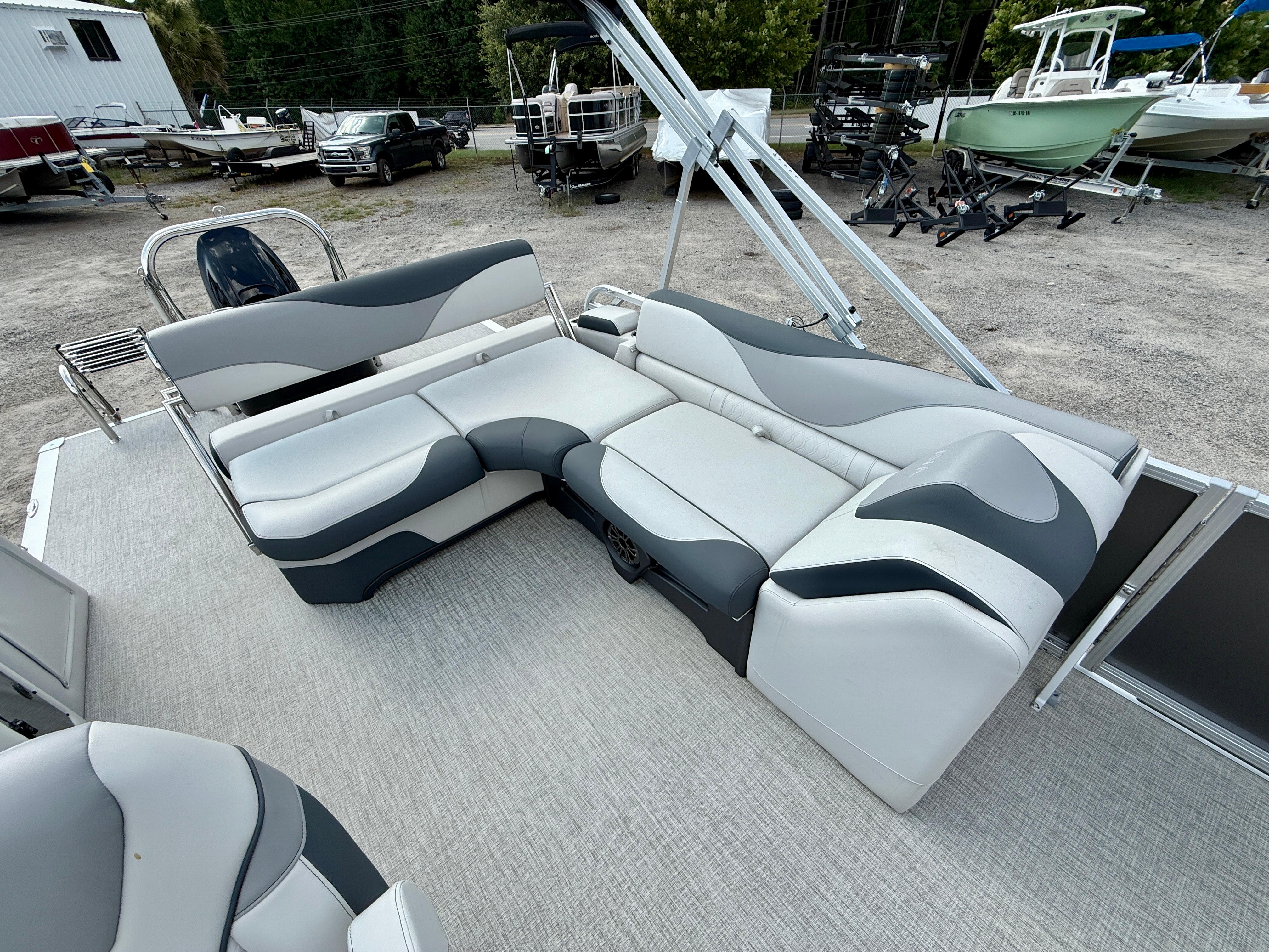 2025 Avalon LSZ Cruise Rear Bench with stylish seating in a boatyard setting.