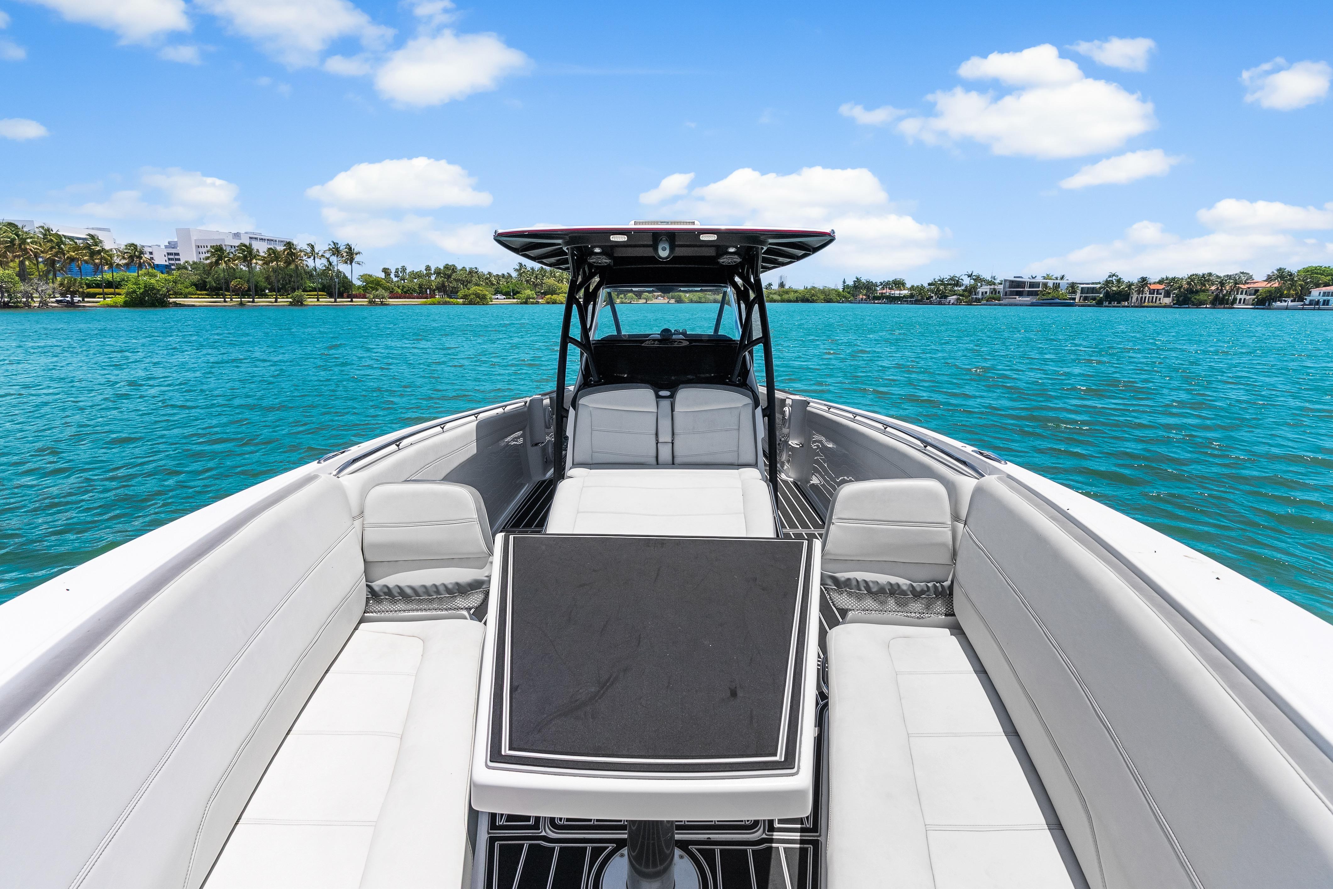 2019 Nor-Tech 390 Sport Center Console on turquoise water, clear sky, luxury seating.