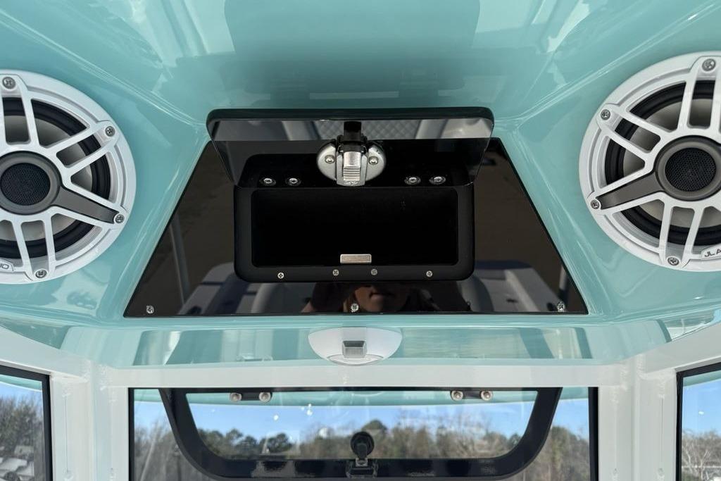 2026 Sportsman Masters 247OE Bay Boat audio system with dual speakers and storage compartment.