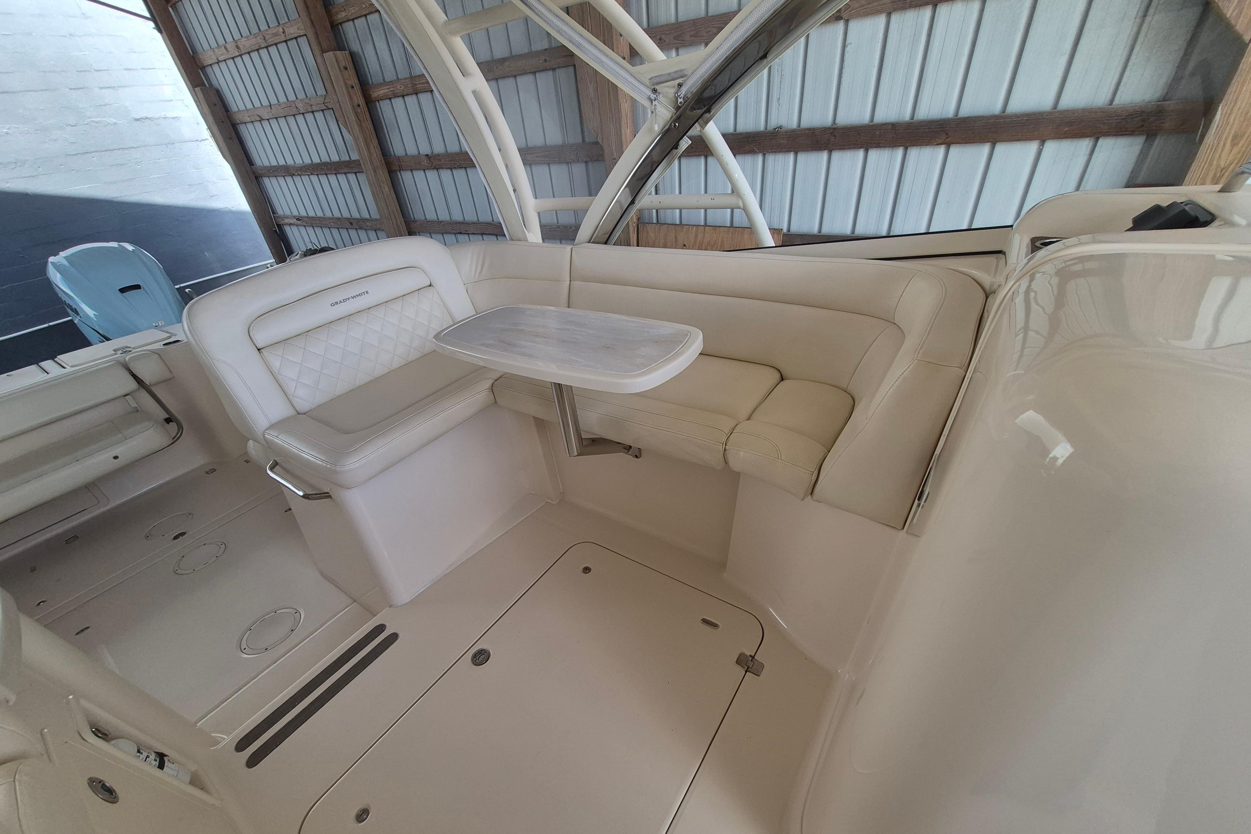 2019 Grady-White Freedom 335 boat interior with seating and table in a covered dock.