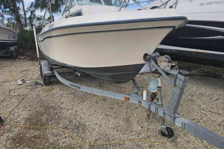 1989 Grady-White Overnighter 204 boat on trailer, parked outdoors.