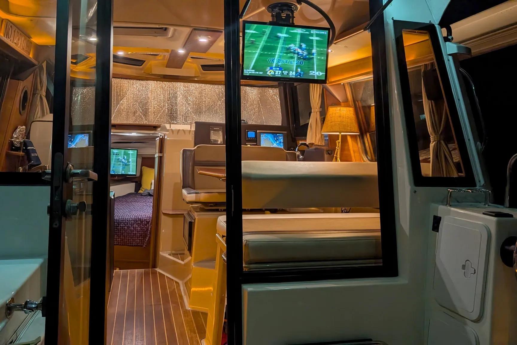 Interior view of 2015 Ranger Tugs R-29 S boat with cozy seating and TV.