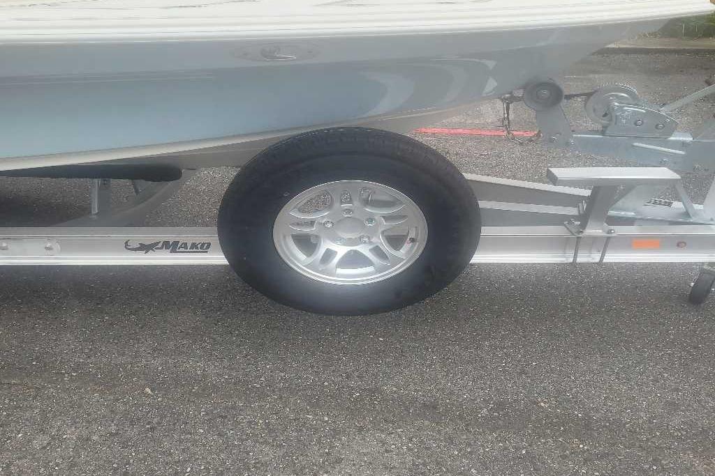 2026 Mako 18 Pro Skiff on trailer, showcasing wheel and hull details.