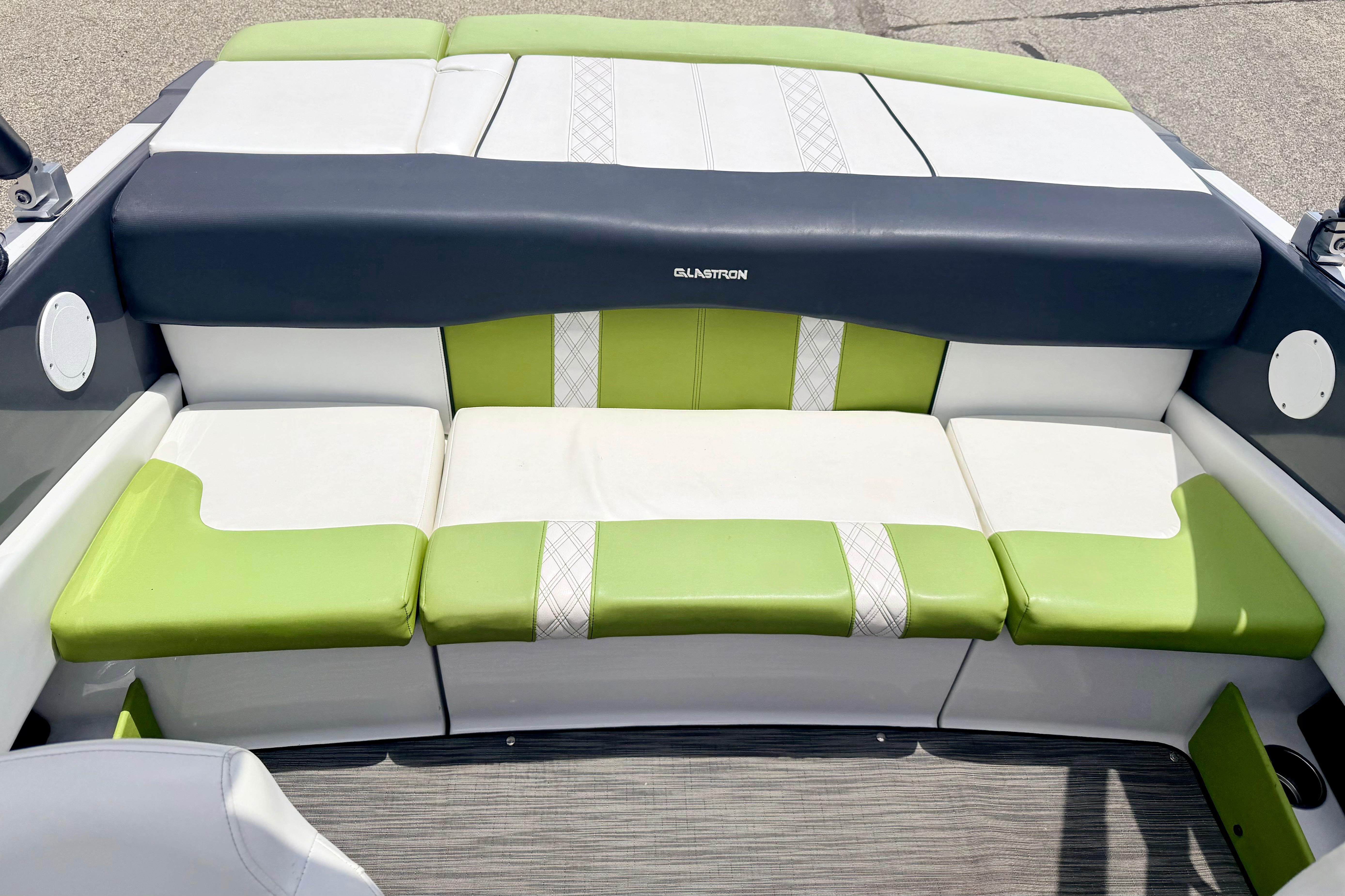 2018 Glastron GT 185 boat interior with green and white cushioned seating.