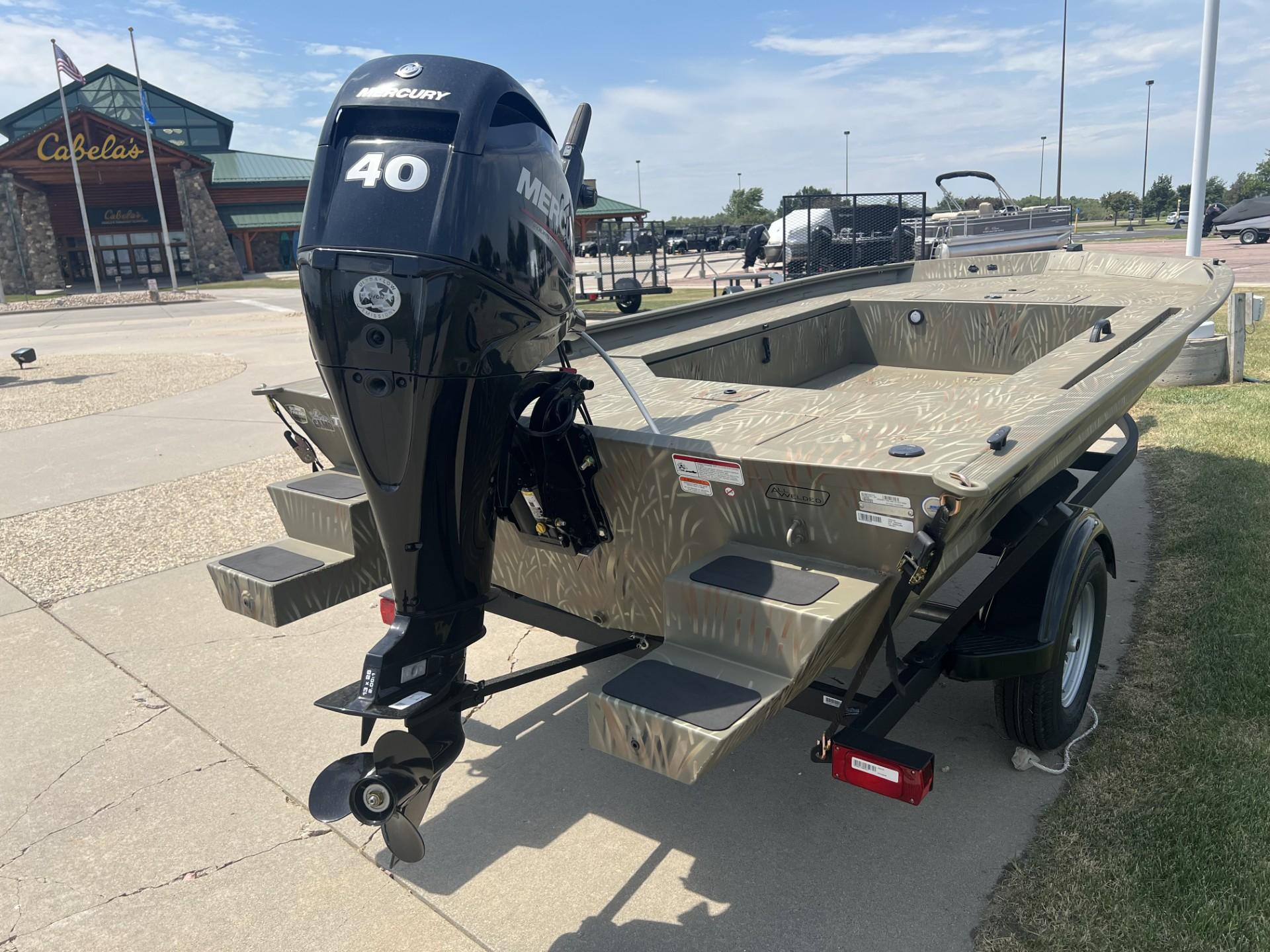 2025 Tracker Grizzly 1654 T Sportsman boat with Mercury 40 engine at Cabela's parking lot.