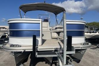 2023 Suntracker G3 Select 322 CC pontoon boat on trailer under blue sky.