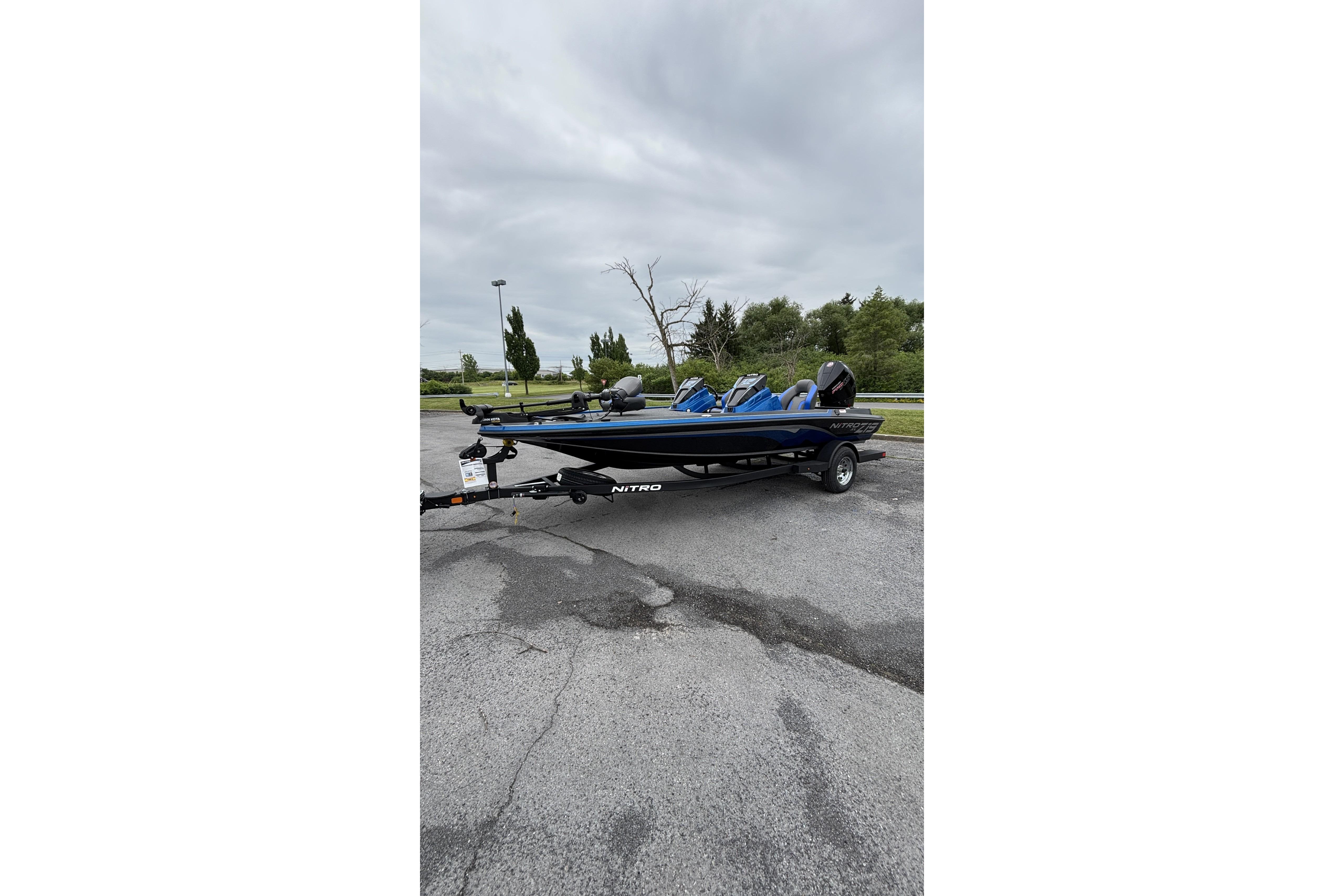 2026 Nitro Z19 XL boat on trailer in parking lot, overcast sky.