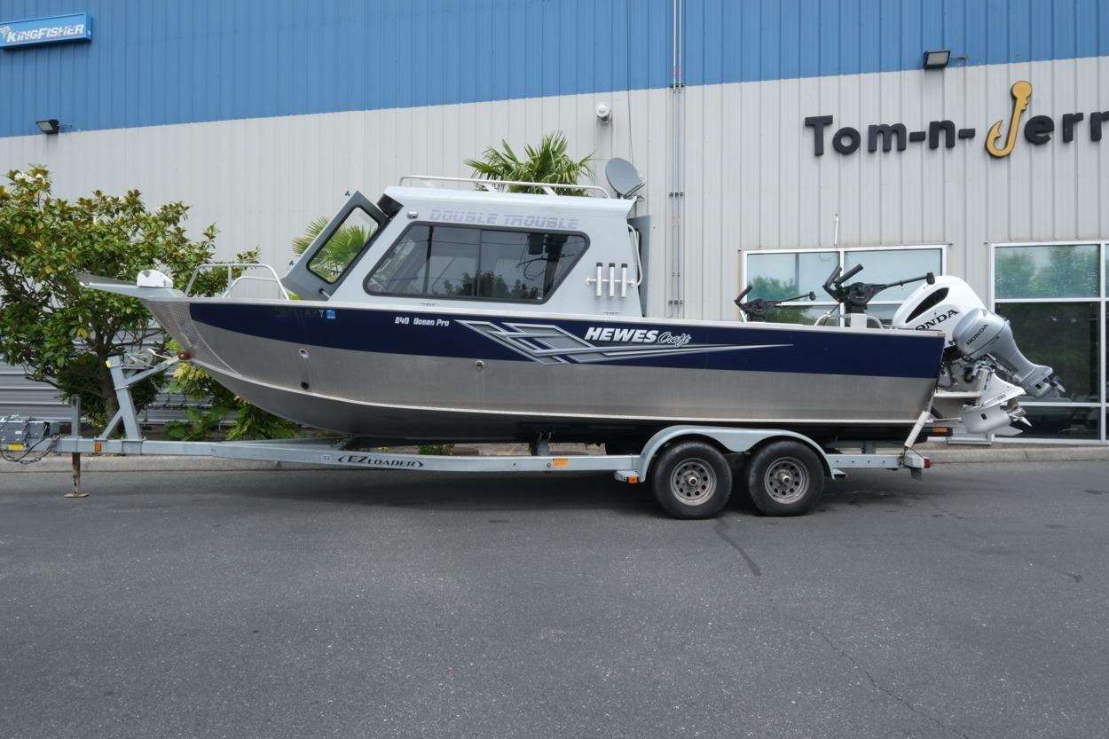 2021 Hewescraft 240 Ocean Pro ET Hardtop boat on trailer outside Tom-n-Jerry building.