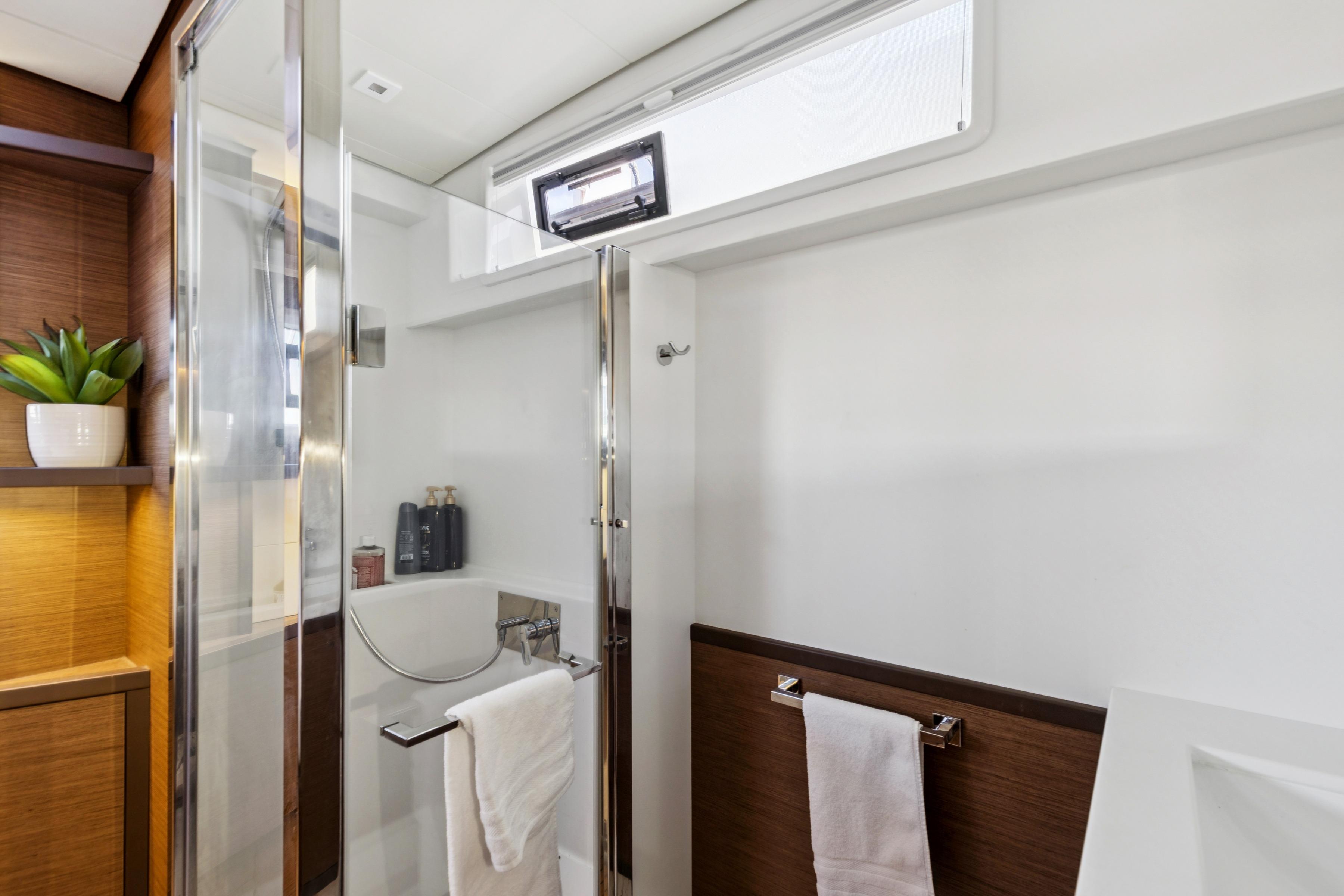 Modern bathroom interior on 2022 Lagoon 52 F yacht, featuring sleek design and elegant fixtures.