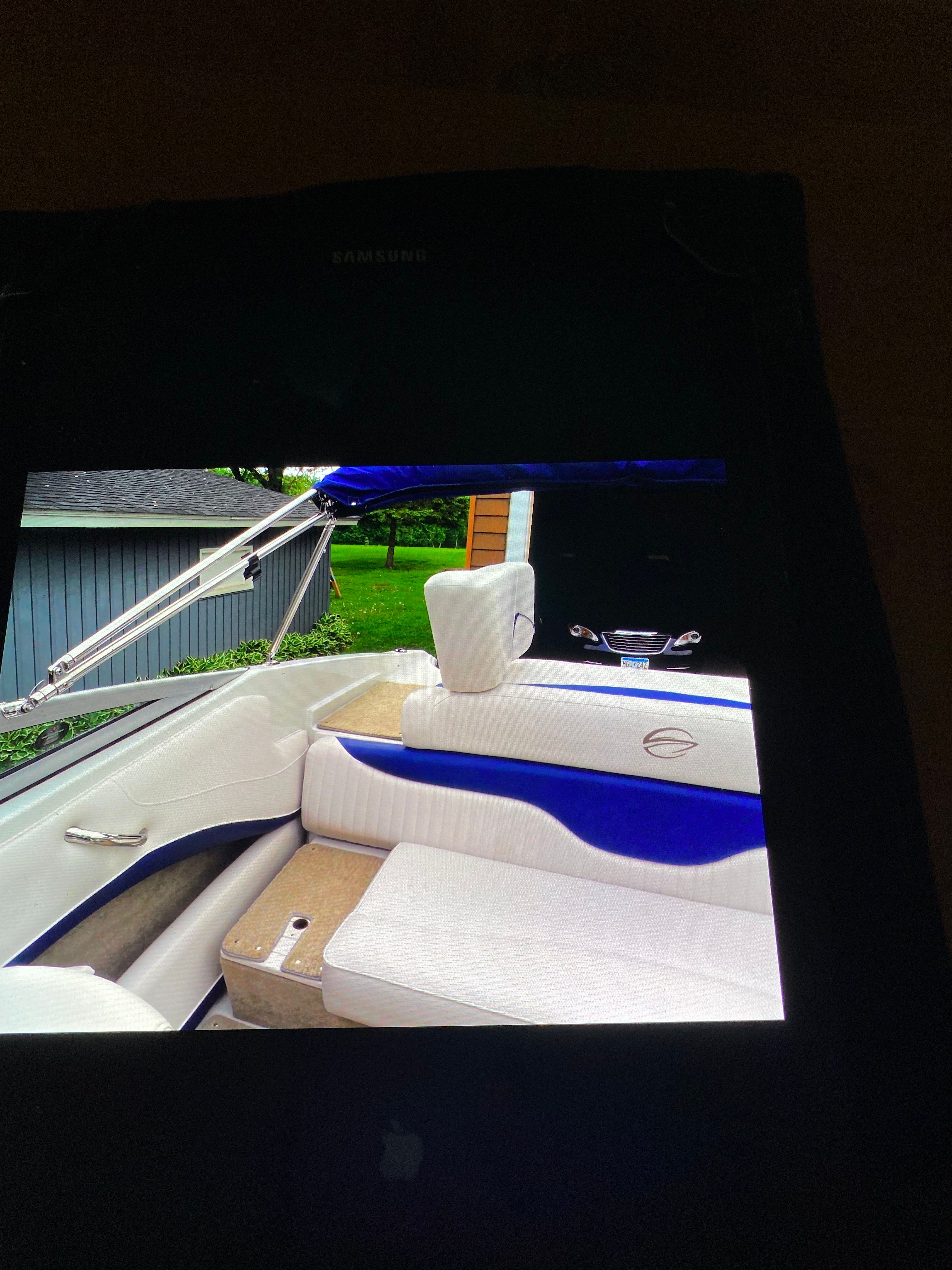 Interior view of a Crownline 21 bow rider with blue and white seating.
