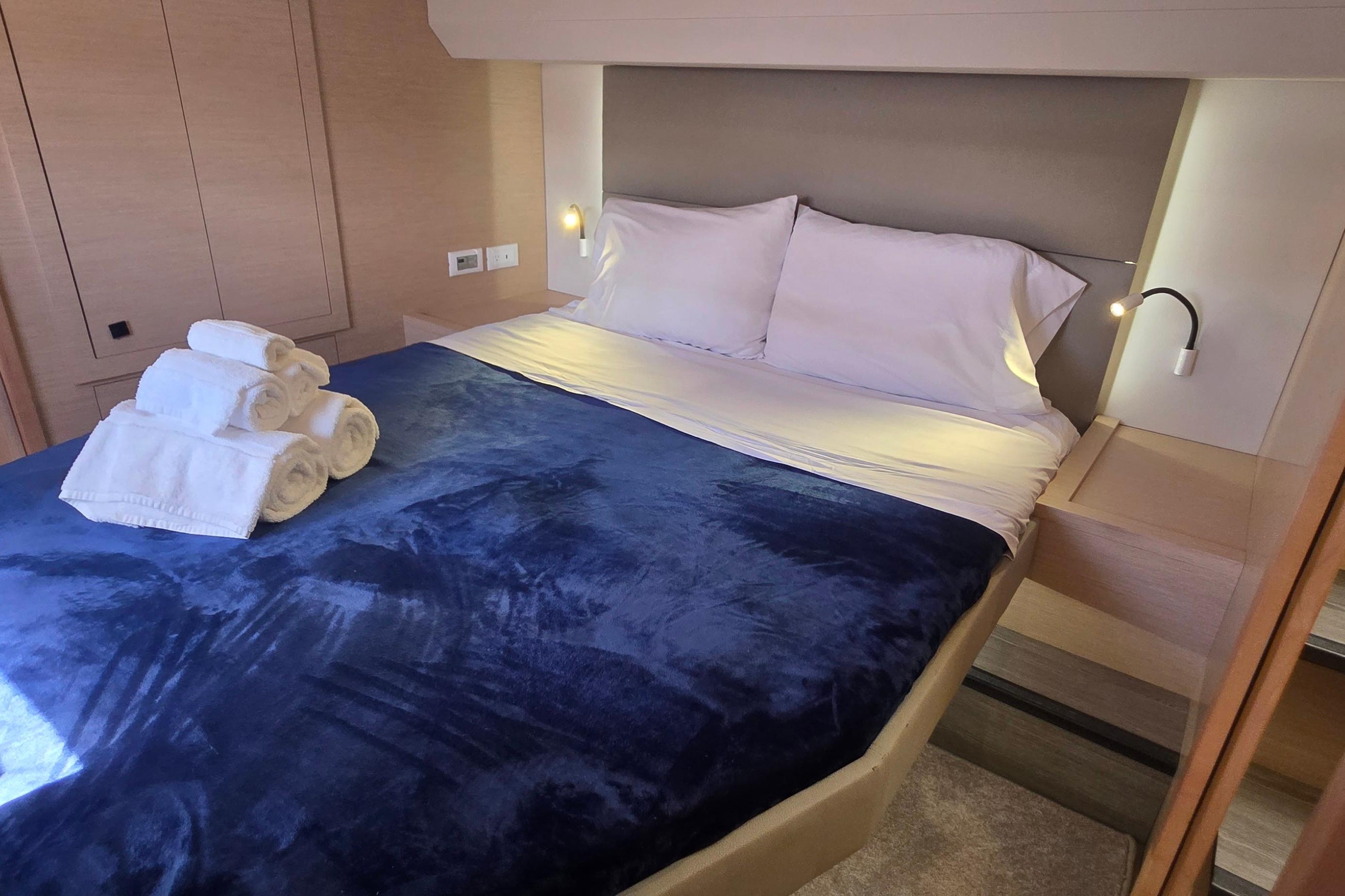 Luxurious bedroom interior of 2018 Fountaine Pajot Motor Yacht 44 with plush bedding.