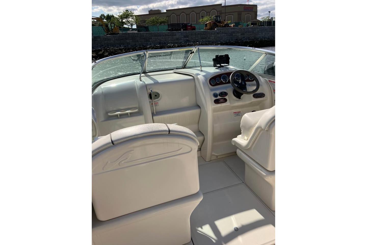 2004 Sea Ray 215 Weekender boat interior with steering wheel and seating.