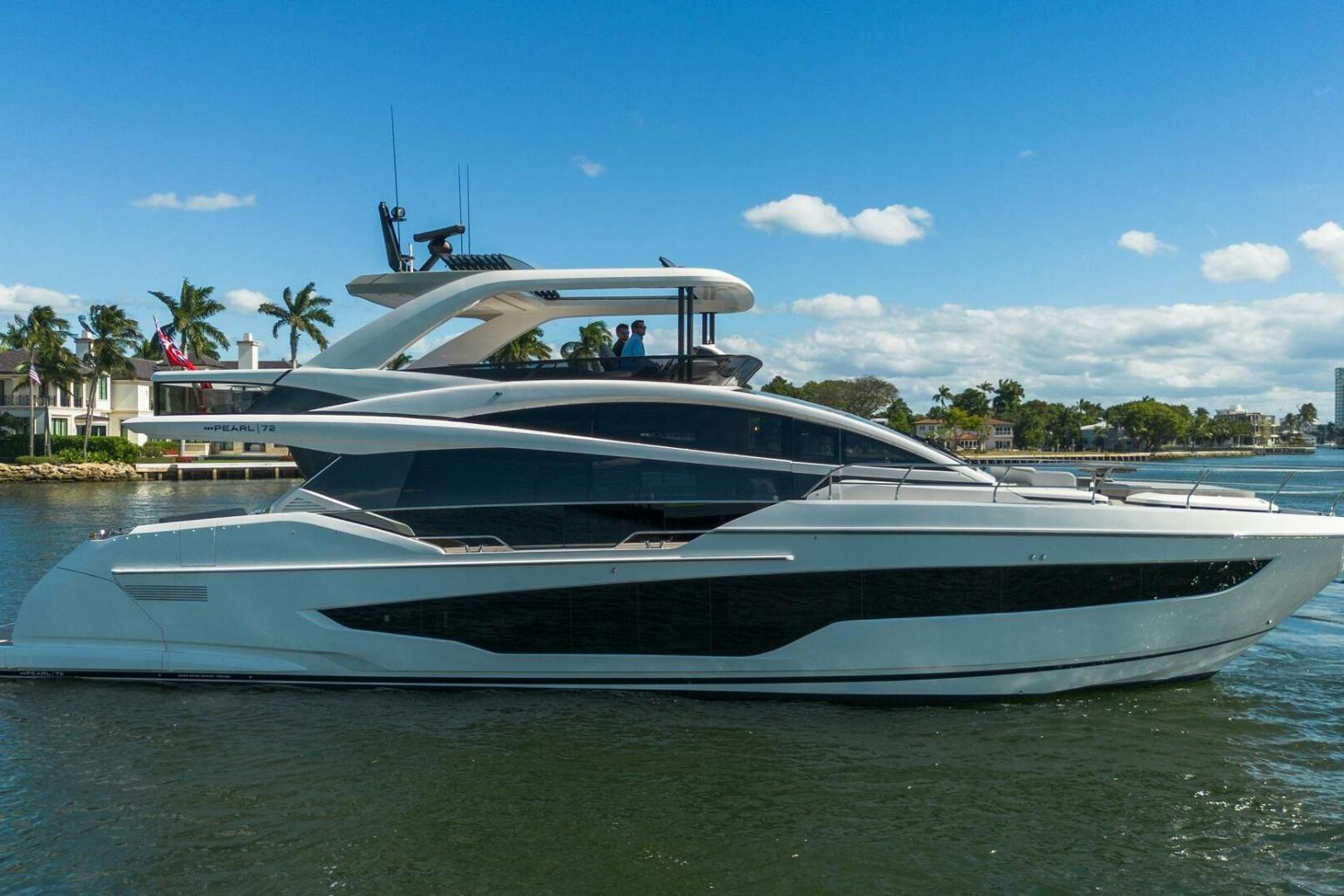 Luxurious 2023 Pearl 72 yacht cruising on a sunny day with palm trees in the background.