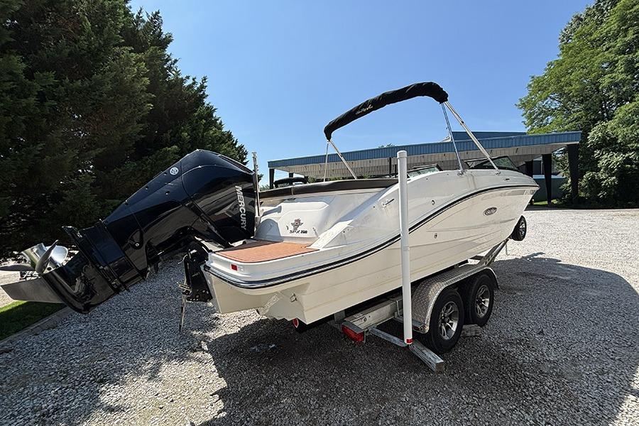 2019 Sea Ray SPX 230 Outboard boat on trailer, parked outdoors under clear sky.