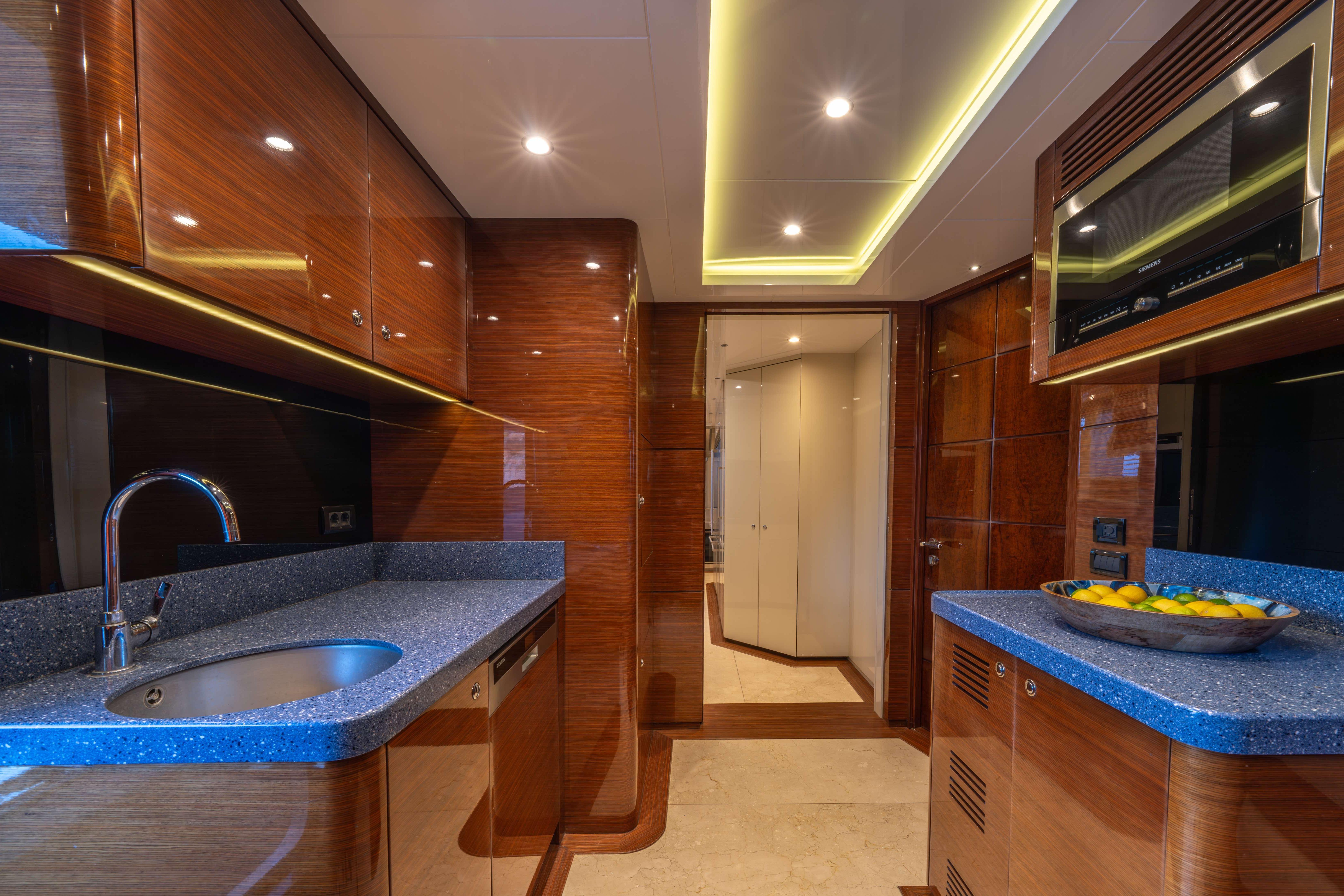 Luxurious Bilgin 147 yacht kitchen with sleek wood cabinetry and modern appliances, 2014 model.