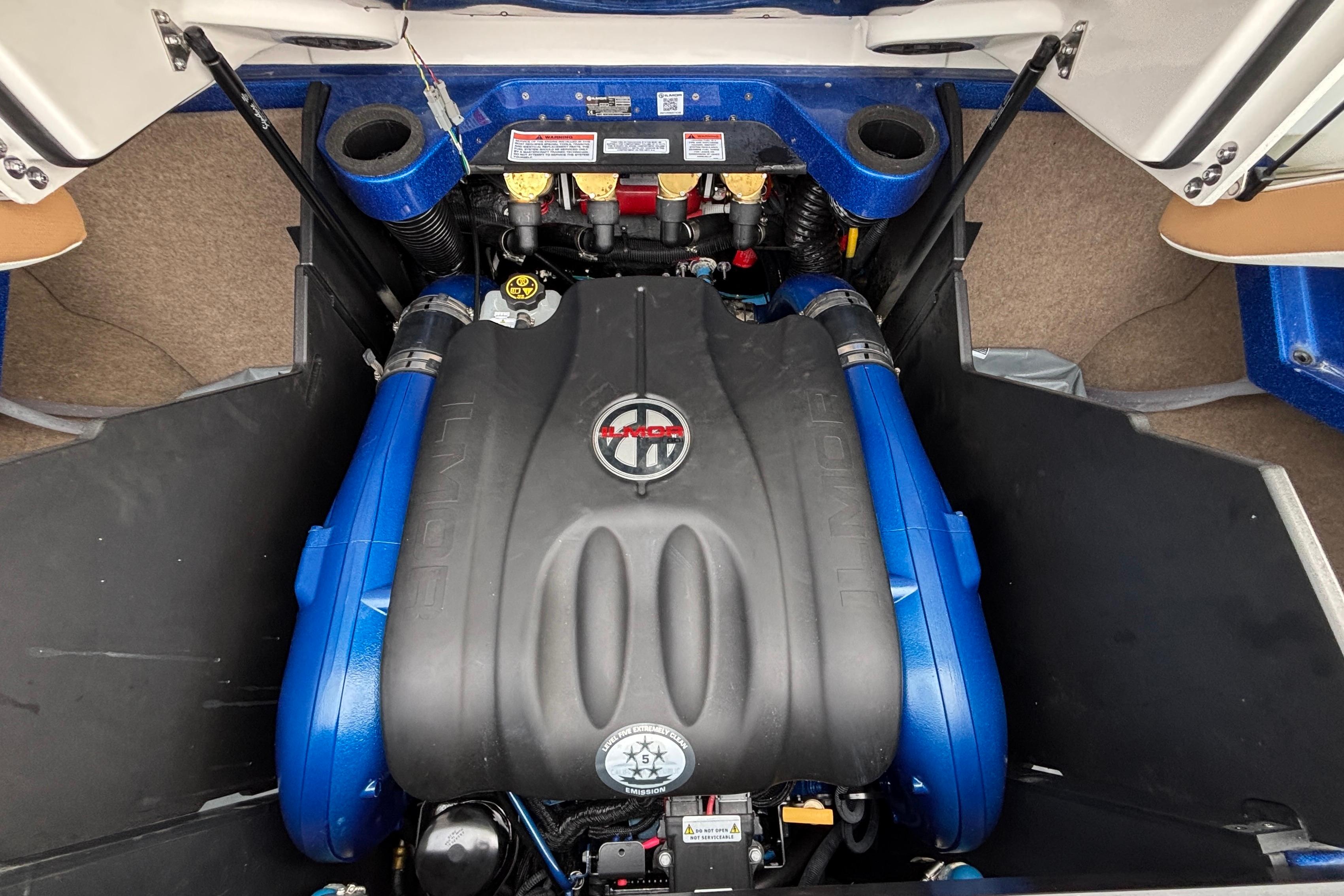 2022 MasterCraft X26 engine compartment with Ilmor marine engine, showcasing blue accents.