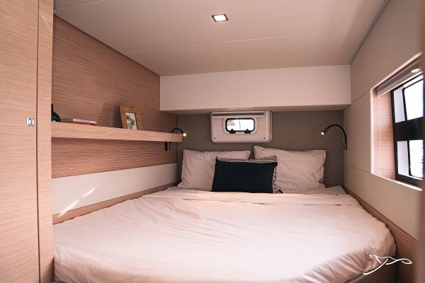 Luxurious cabin interior of 2025 Nautitech 40 Open catamaran with cozy bedding and modern design.