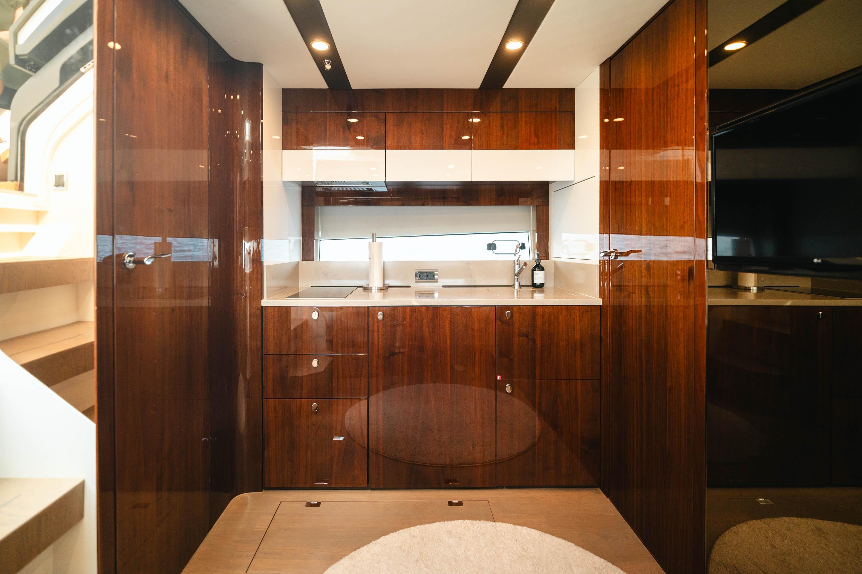 Luxurious interior of 2020 Fairline Targa 45 Open yacht with sleek wooden cabinetry.