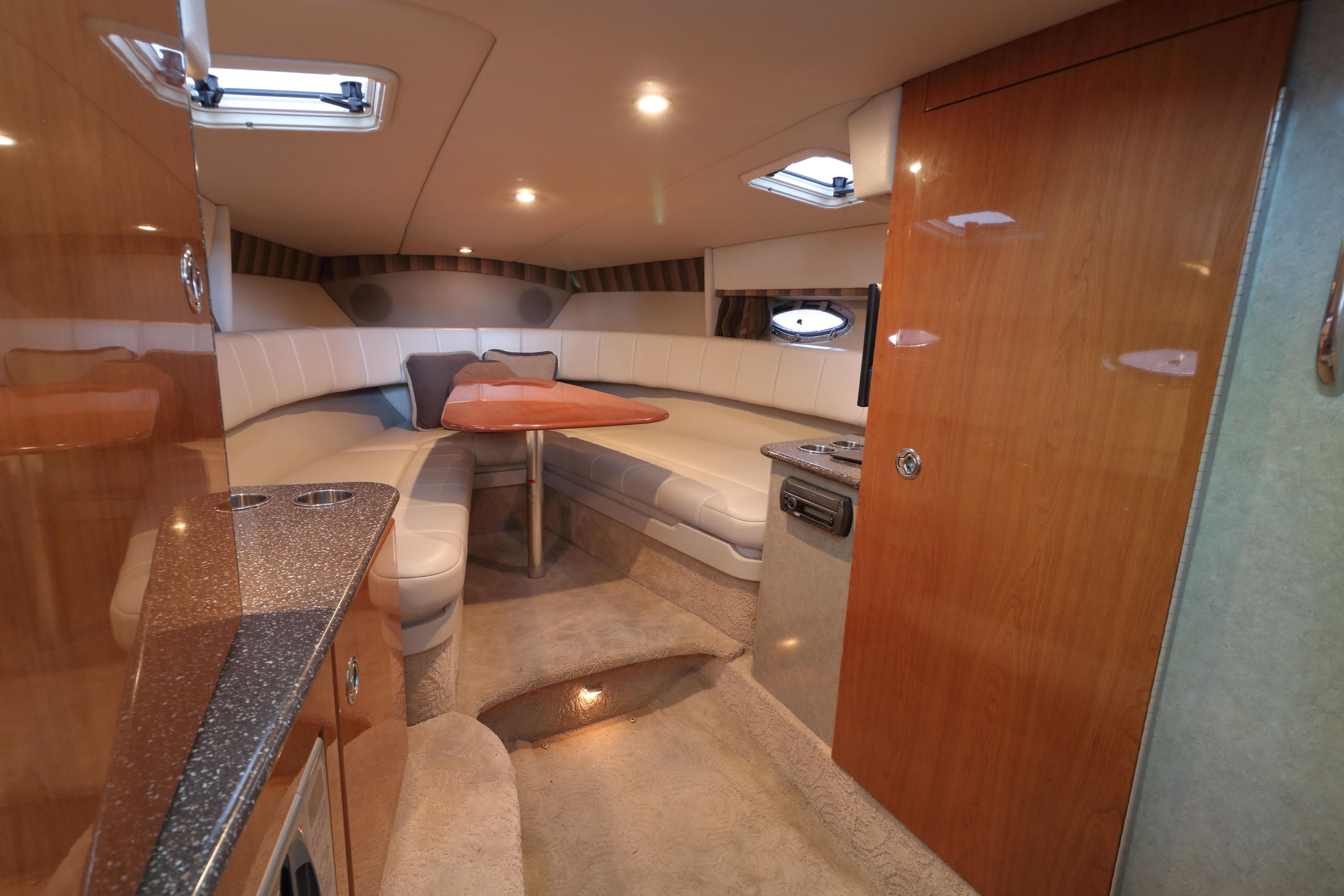 Luxurious interior of a 2006 Formula 330 Sun Sport boat with plush seating and elegant wood finishes.