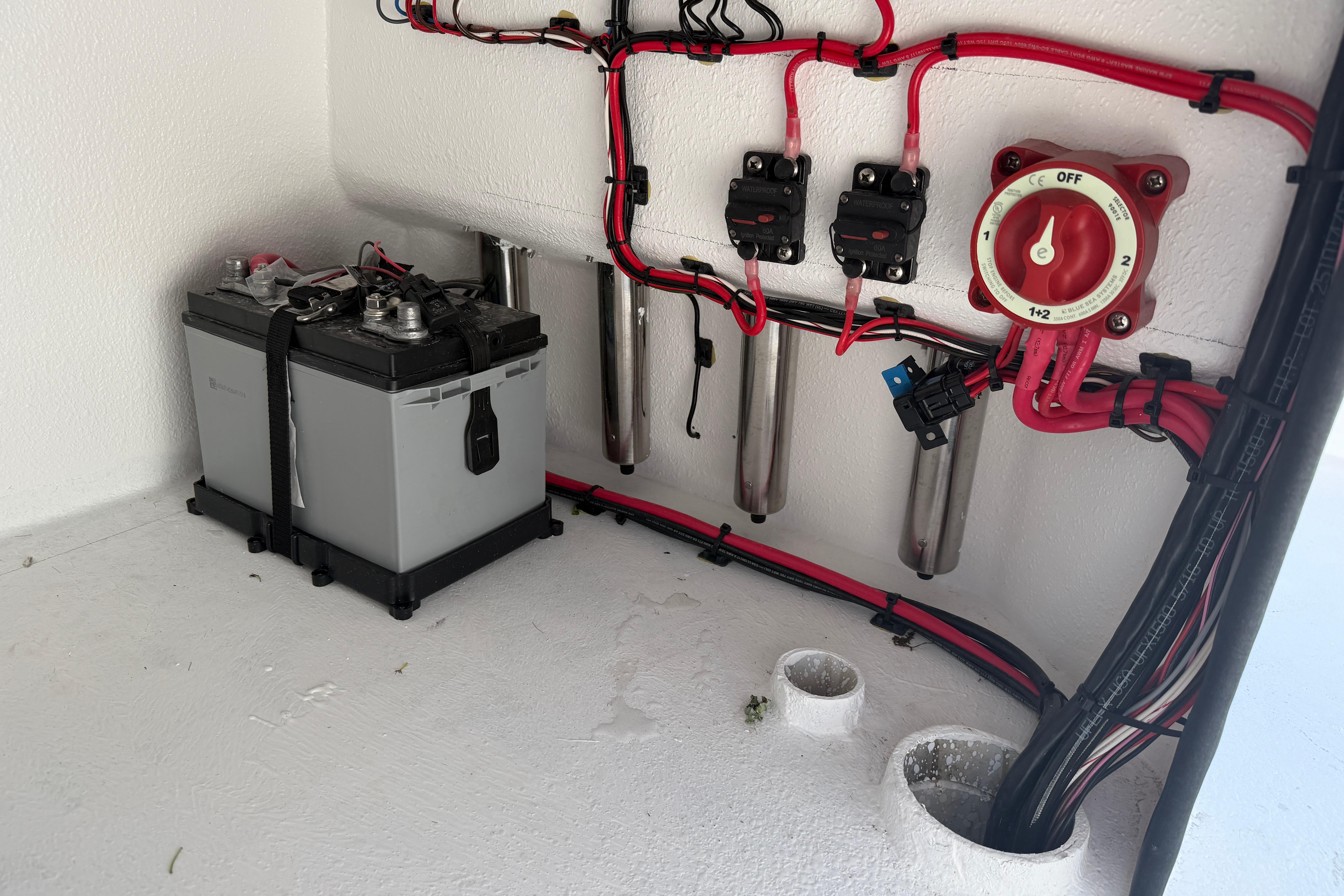Electrical setup in a 2026 Skuta 24 Cat boat, featuring battery and wiring.