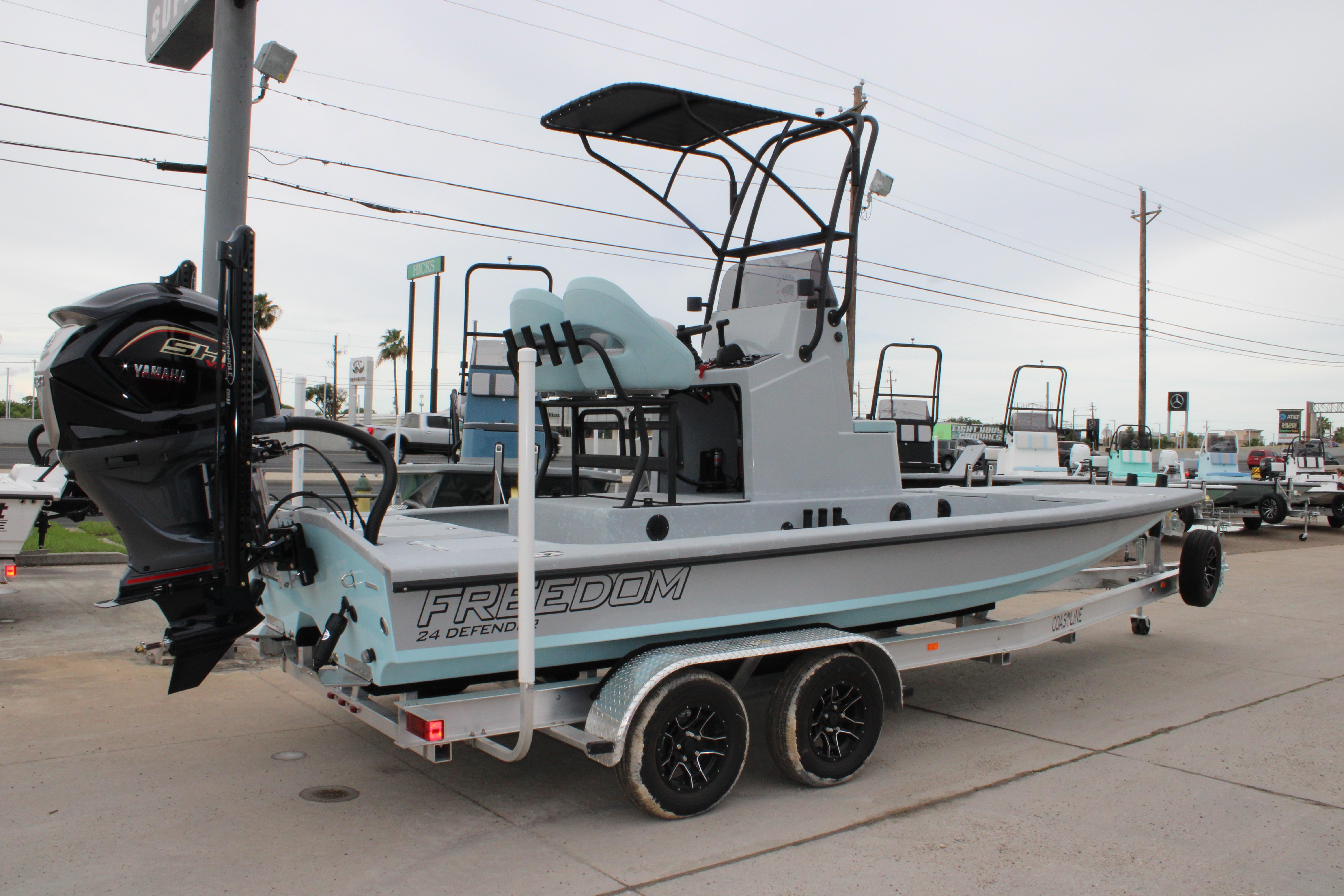 2026 Freedom Boats 24 Defender on trailer, featuring Yamaha outboard motor.