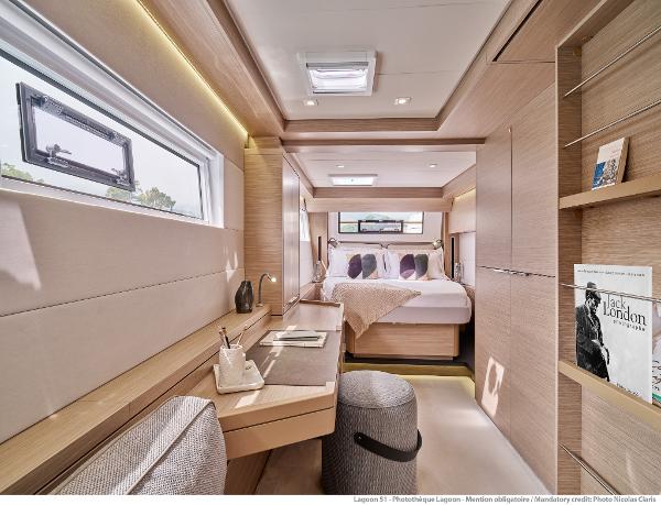 Luxurious interior of 2025 Lagoon 51 ICONIC yacht with modern design and cozy bedroom.