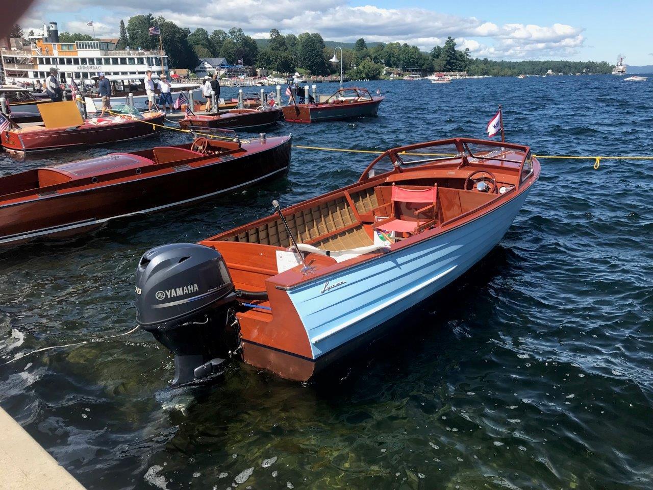 1956 Lyman 18 Outboard boat with Yamaha motor docked on a sunny day.