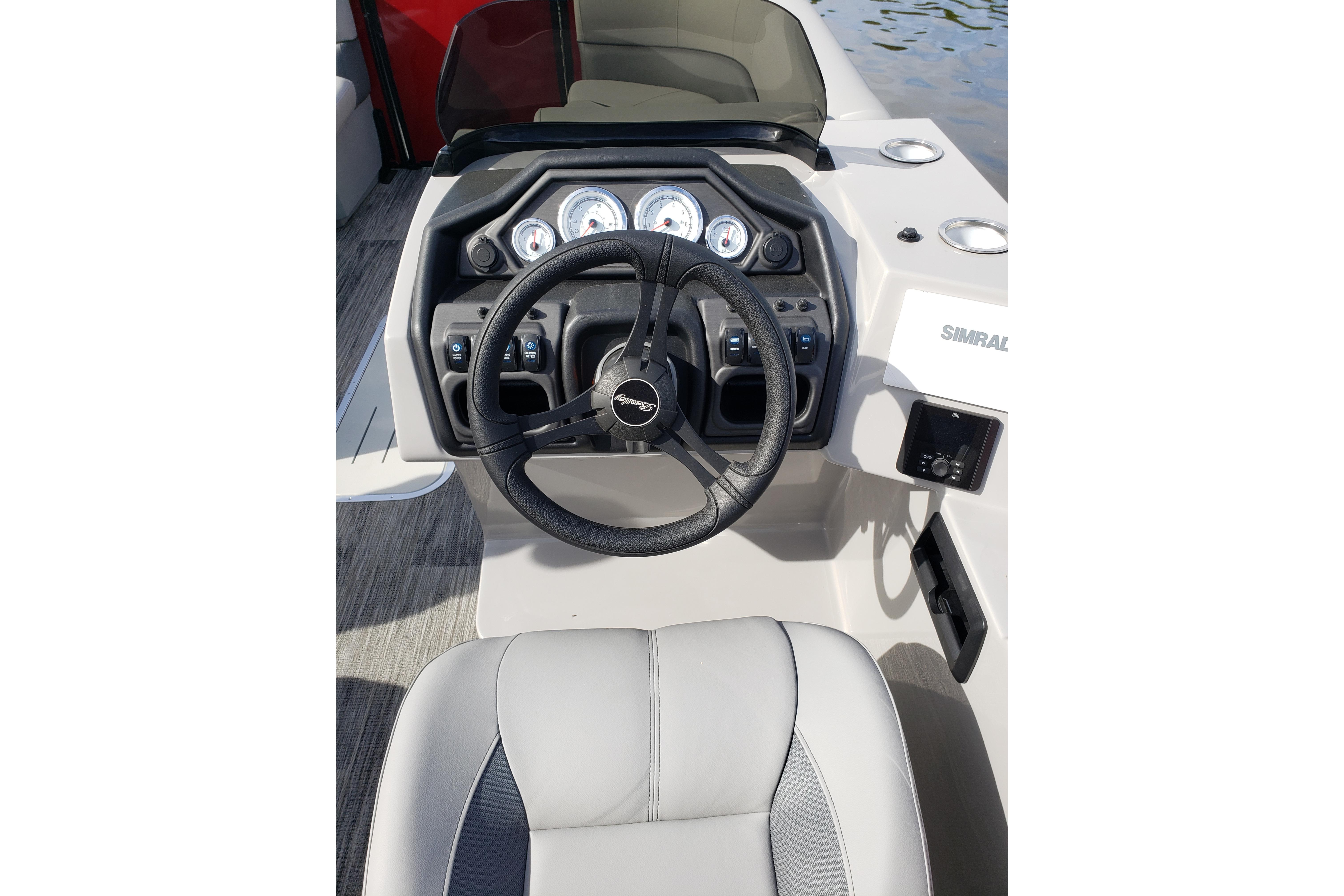 Steering console of 2026 Bentley Pontoons Legacy 243 Navigator Ext with gauges and controls.